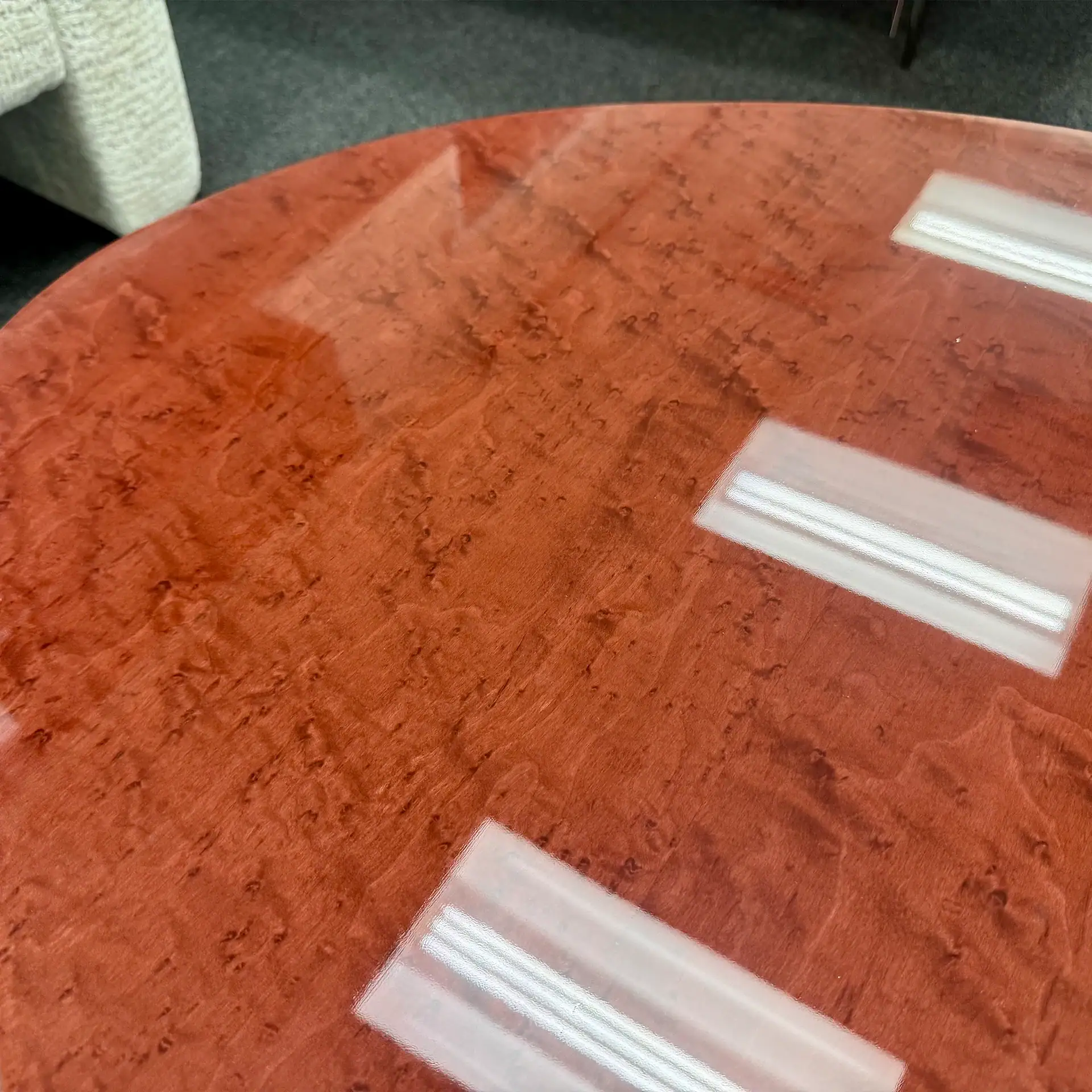 Close-up of a polished wooden coffee table with a glossy finish.