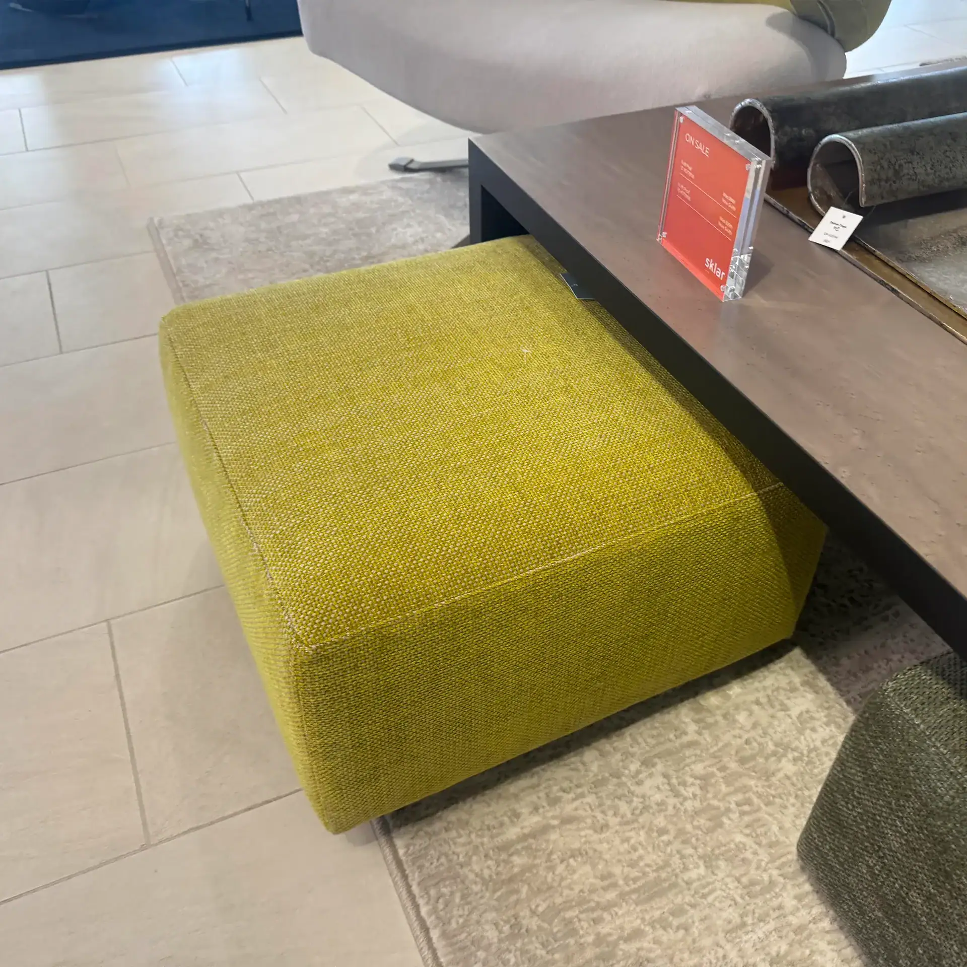 Green fabric pouf from Il Loft Dilmos collection, perfect for contemporary living spaces.
