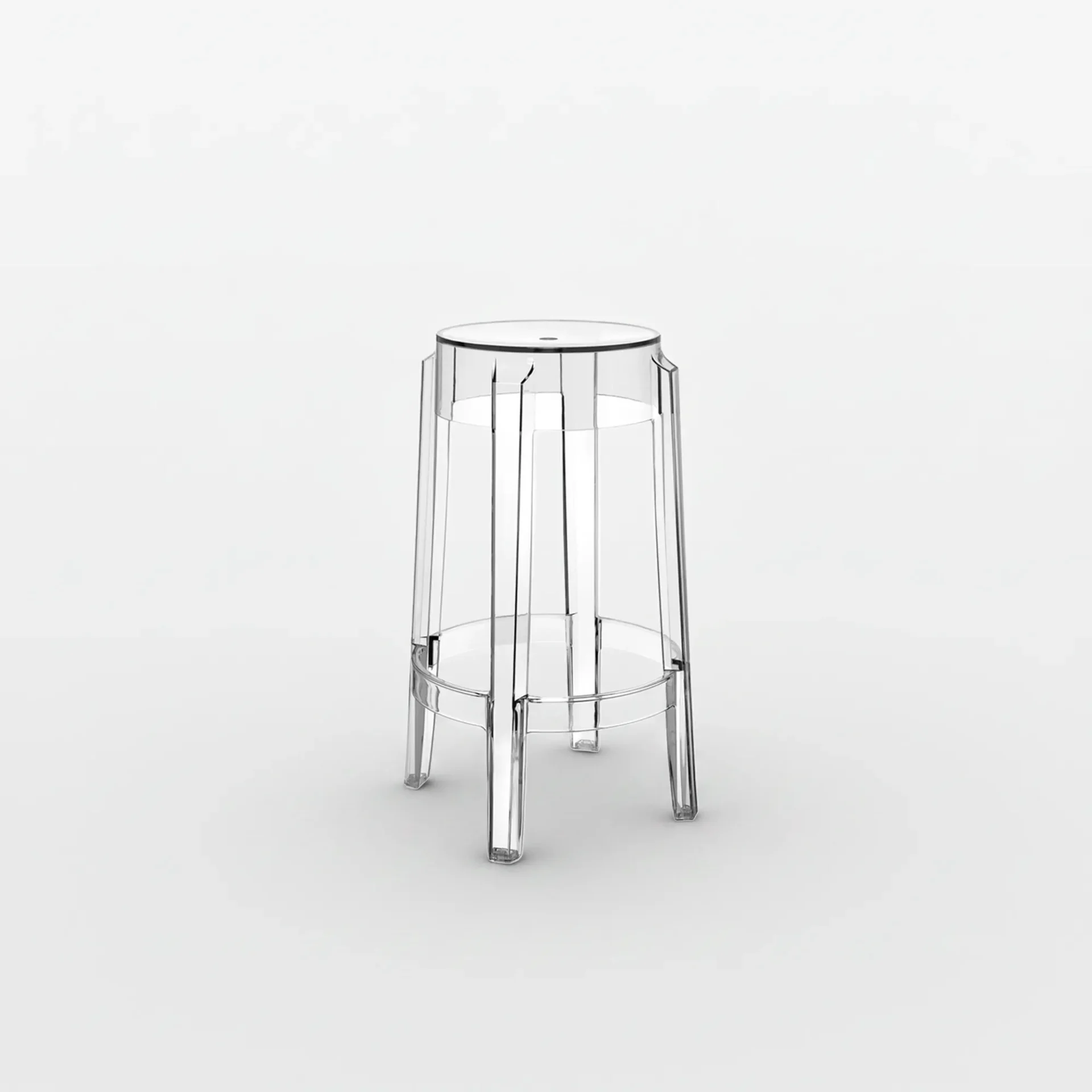 A clear, transparent acrylic stool with a faceted design and integrated footrest, set against a white background.