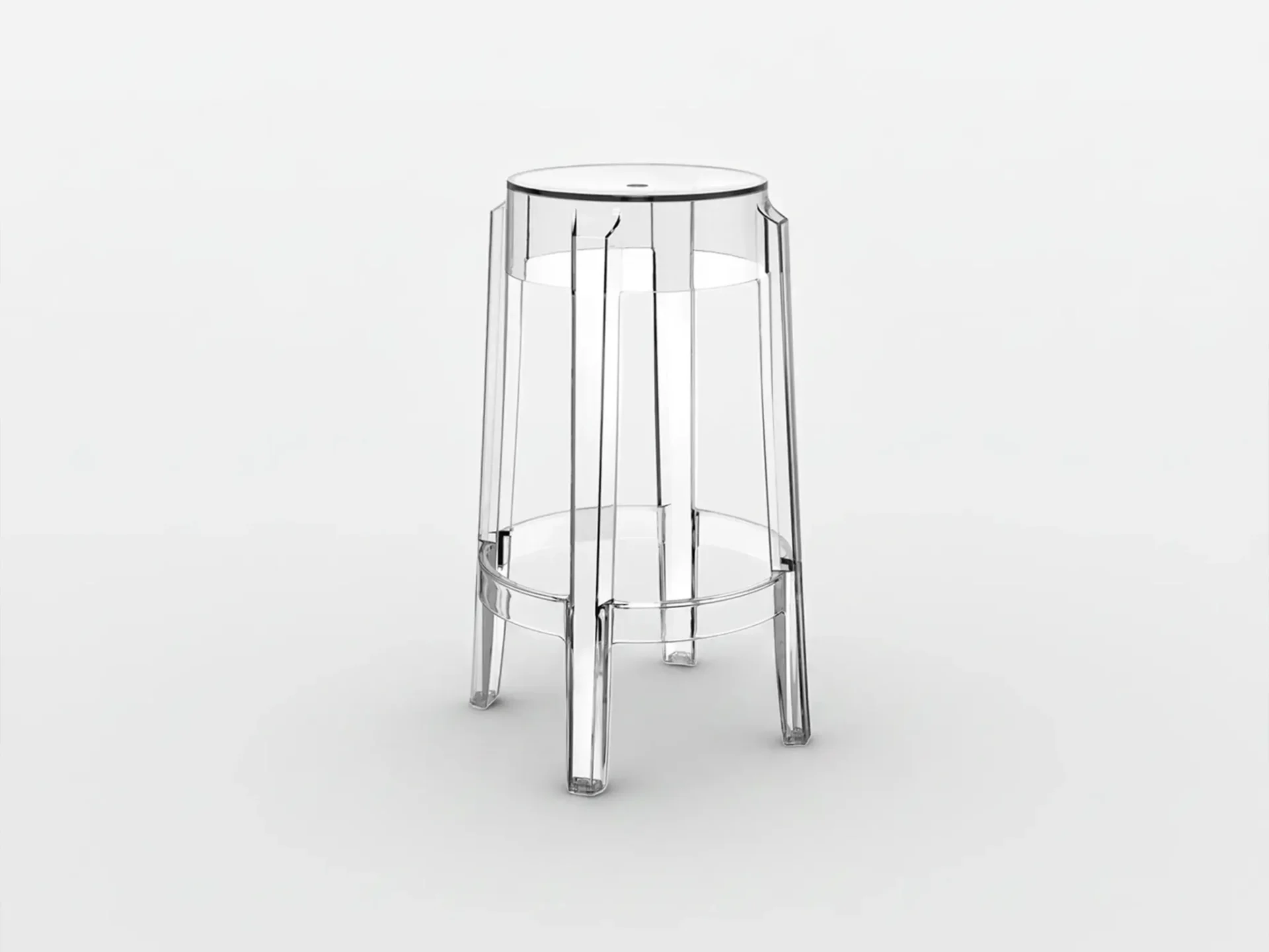 A clear, transparent plastic bar stool with a round seat and segmented cylindrical body, featuring four legs and a footrest ring, on a white background.