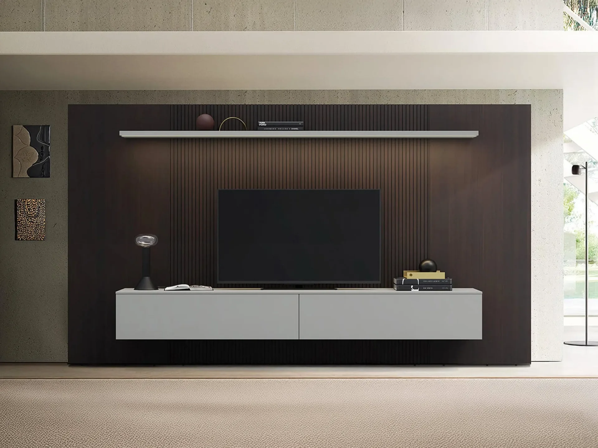 A modern living room with a large TV mounted on a dark, slatted wall panel above a light gray floating console, flanked by abstract art and a large window.
