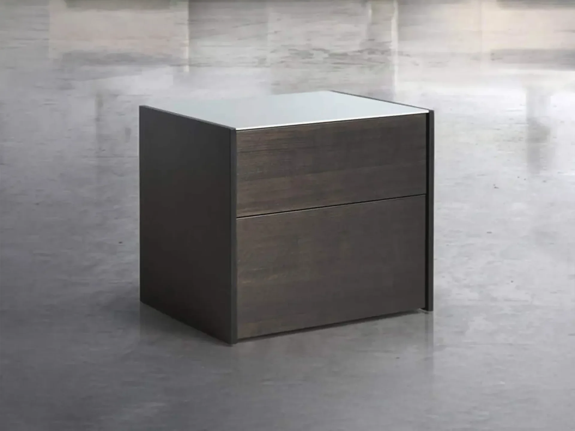 A modern dark wood nightstand with two drawers and a light, reflective top, sitting on a light grey reflective floor.