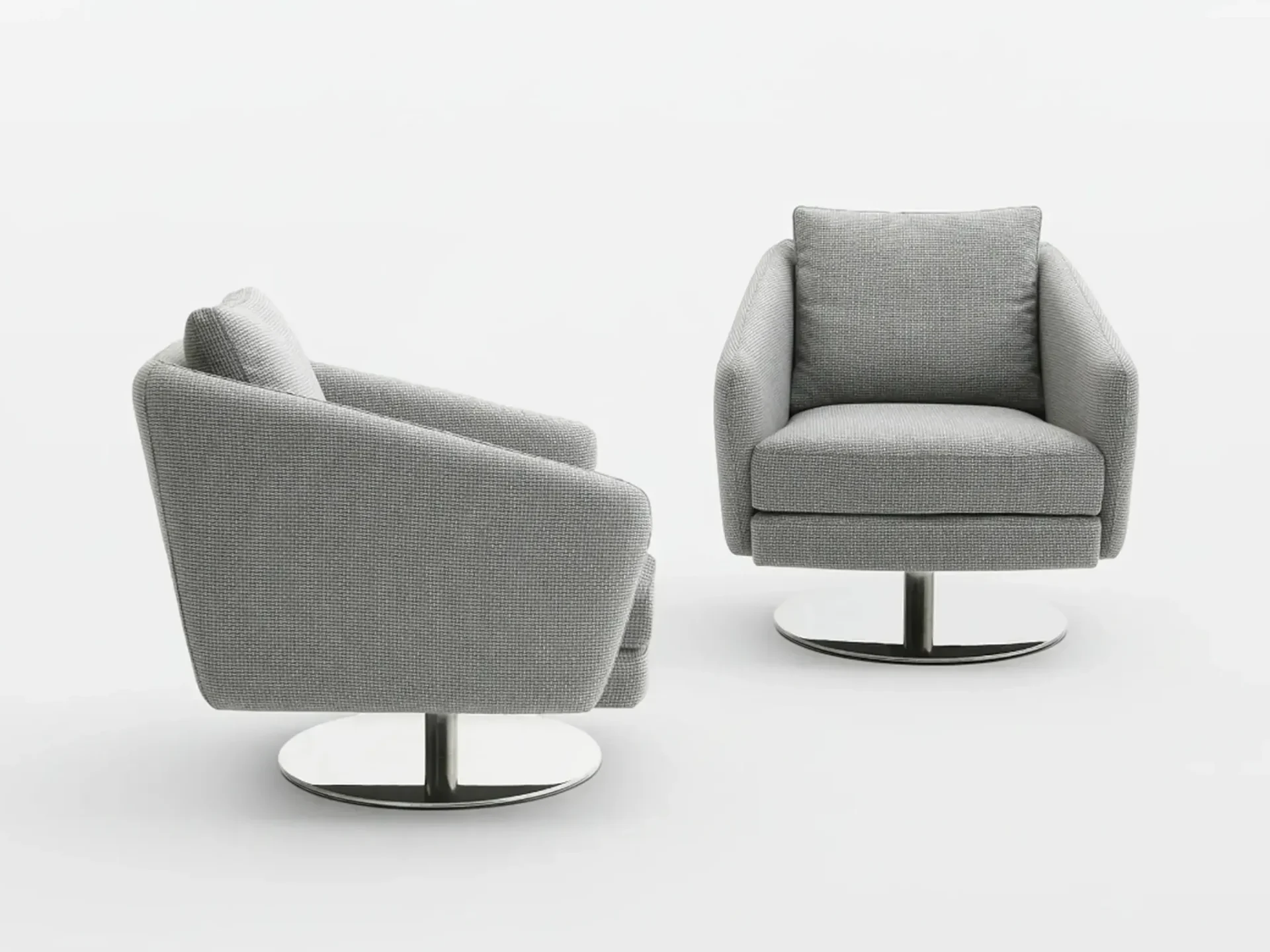 Two gray upholstered swivel armchairs with chrome bases on a white background. One chair is angled, the other faces forward.