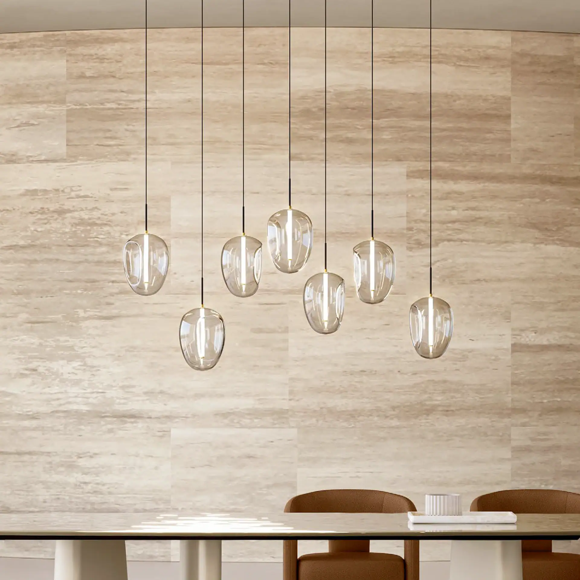 Fos glass pendant light hanging above a dining table, perfect for contemporary and stylish home deco.