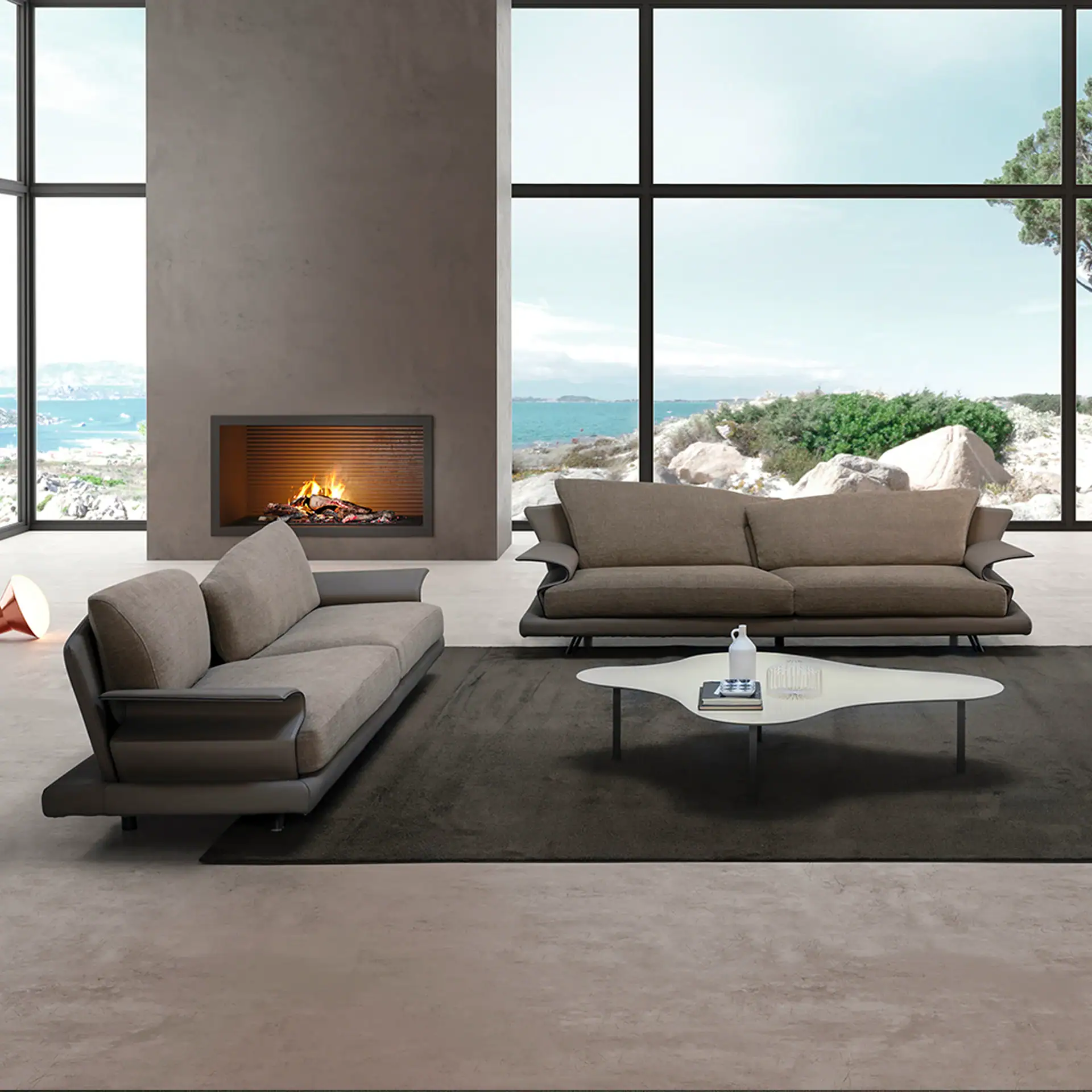 Modern Super Roy sofa set in a stylish living room with large windows and fireplace.