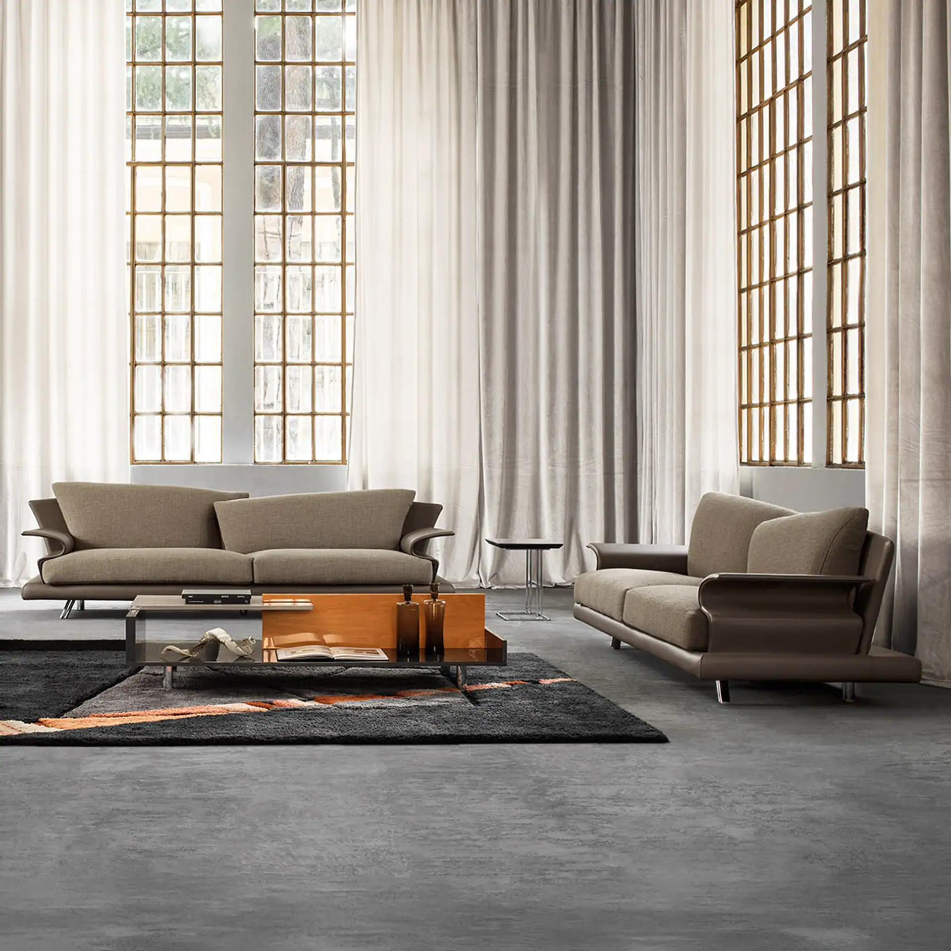 Stylish Super Roy sofa in a contemporary living room setting with large windows and neutral tones.