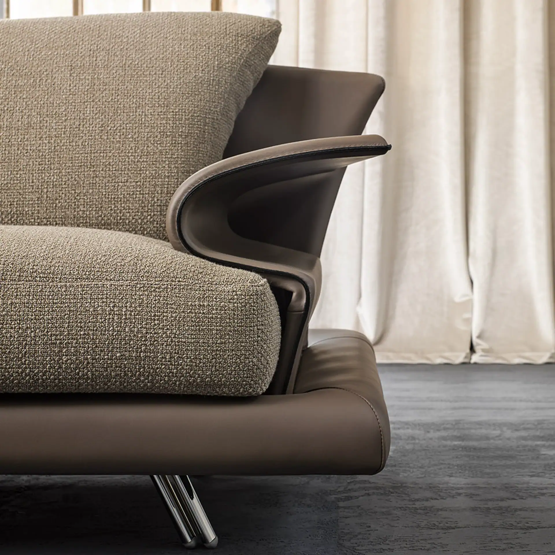 Close-up of the Super Roy sofa with textured fabric and sleek armrest design.