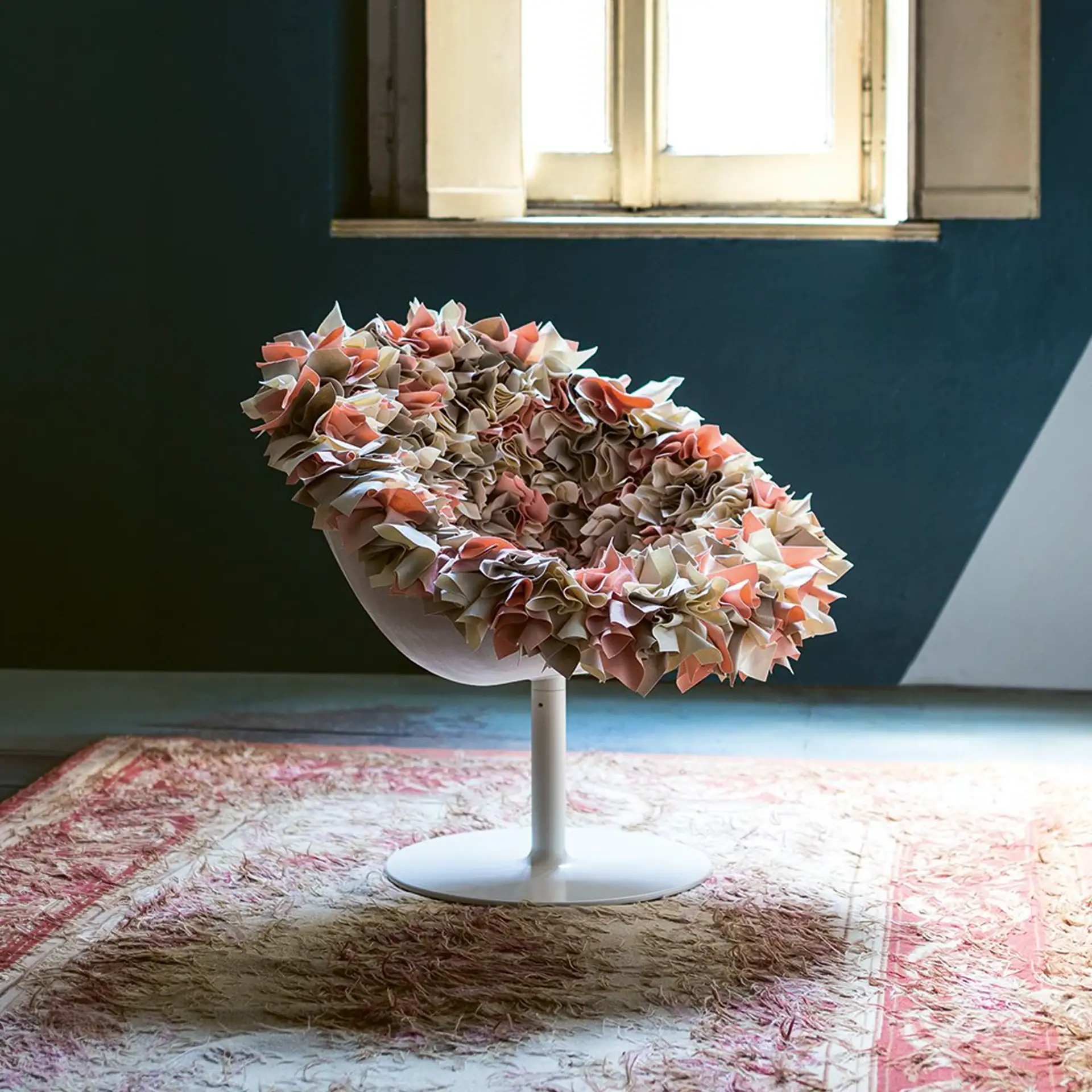 Unique bouquet-inspired swivel armchair with floral fabric design.