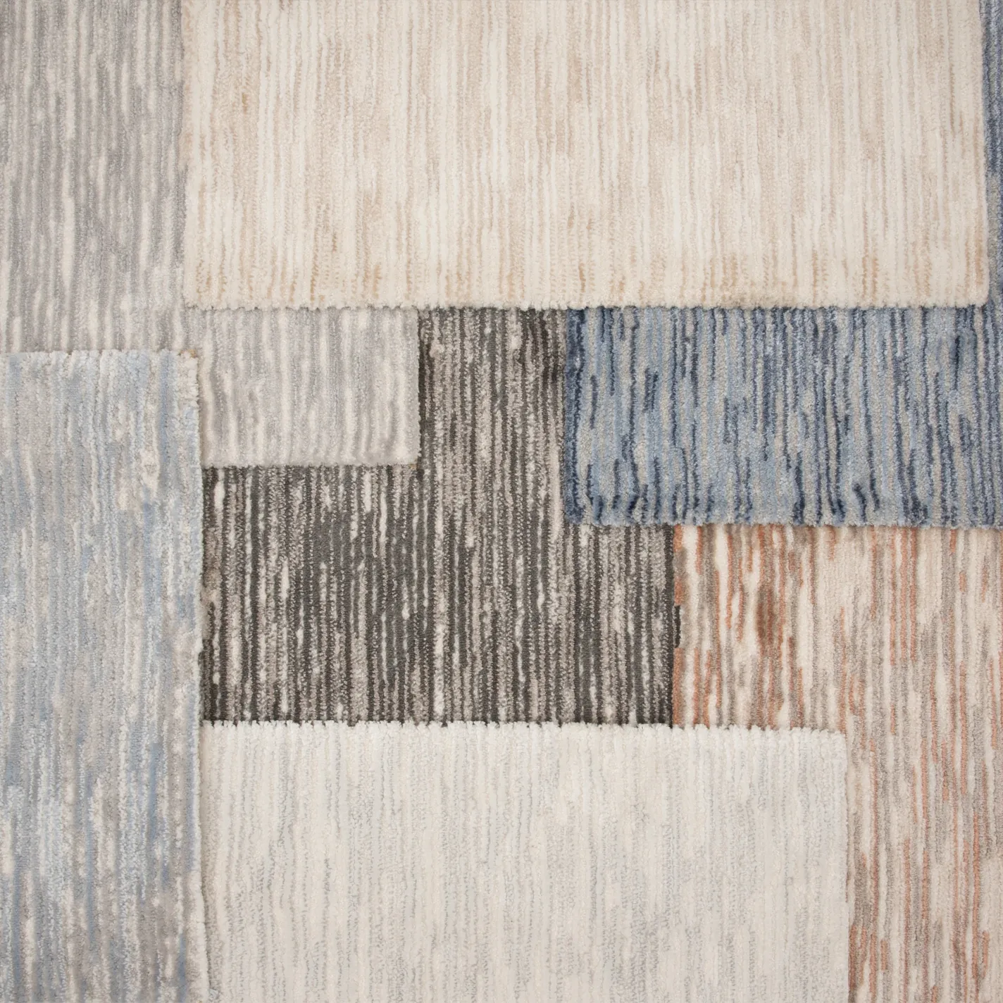 Overlapping rectangular carpet samples in various neutral, blue, and rust tones, featuring distinct striped and textured patterns.