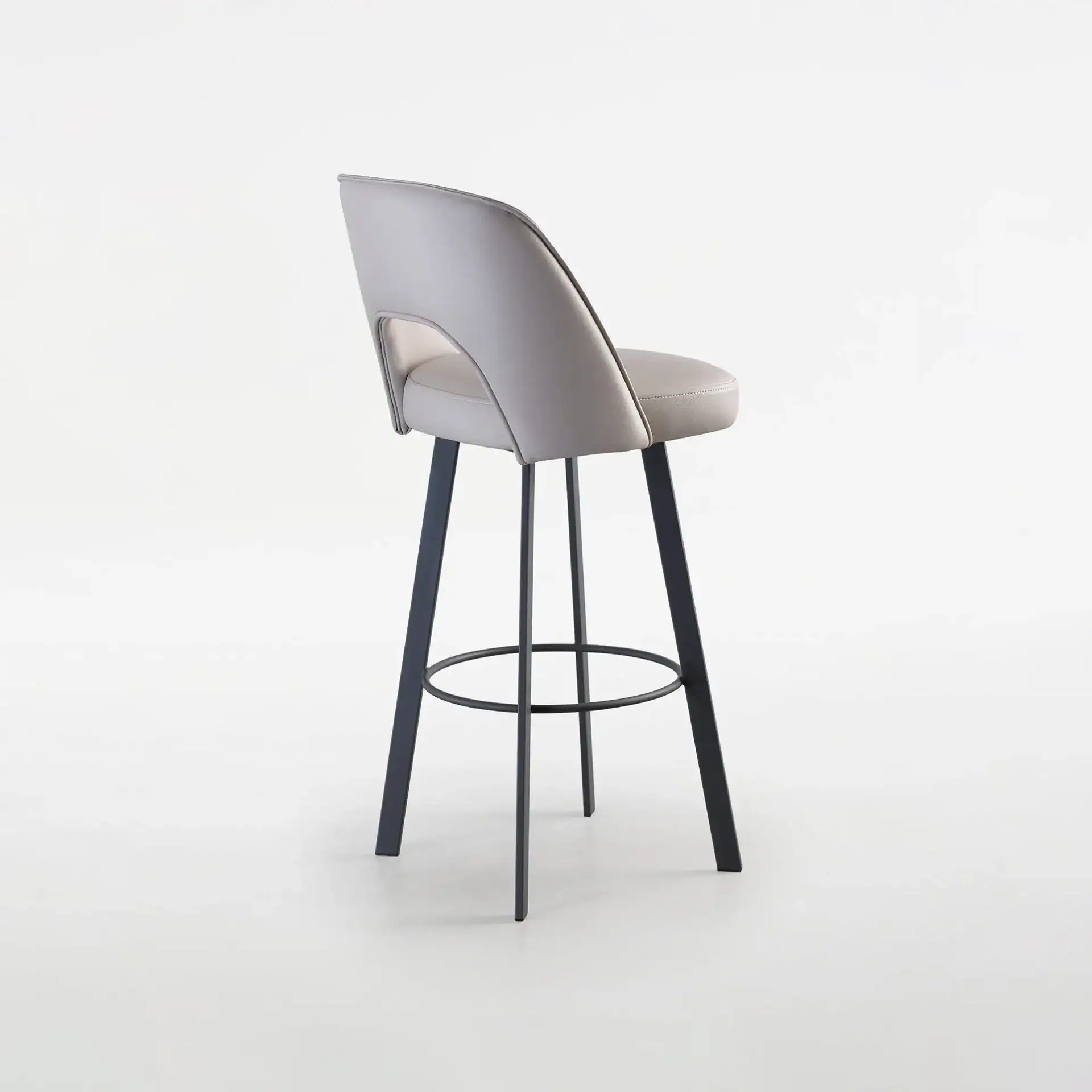 Sklar Furnishings Mia upholstered bar stool with backrest and black legs.