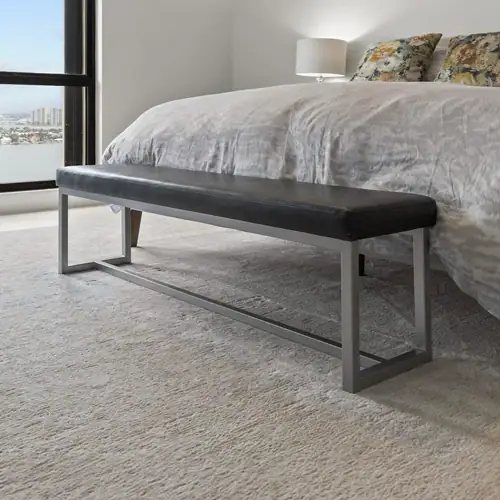 Contemporary bedroom bench with black leather cushion and sleek metal frame, ideal for modern bedroo.
