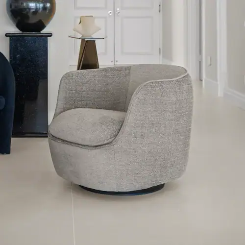 Grey swivel armchair for contemporary living room decor.