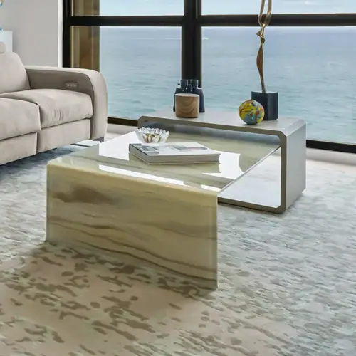 Modern marble coffee table in a contemporary living room with ocean view.