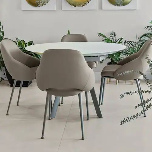 Modern beige dining chairs around a white table with green plants in a stylish interior.