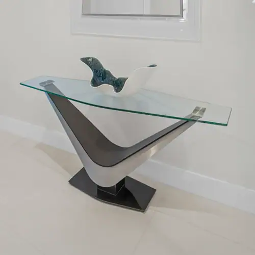 Contemporary glass and metal console table with unique V-shaped base design.