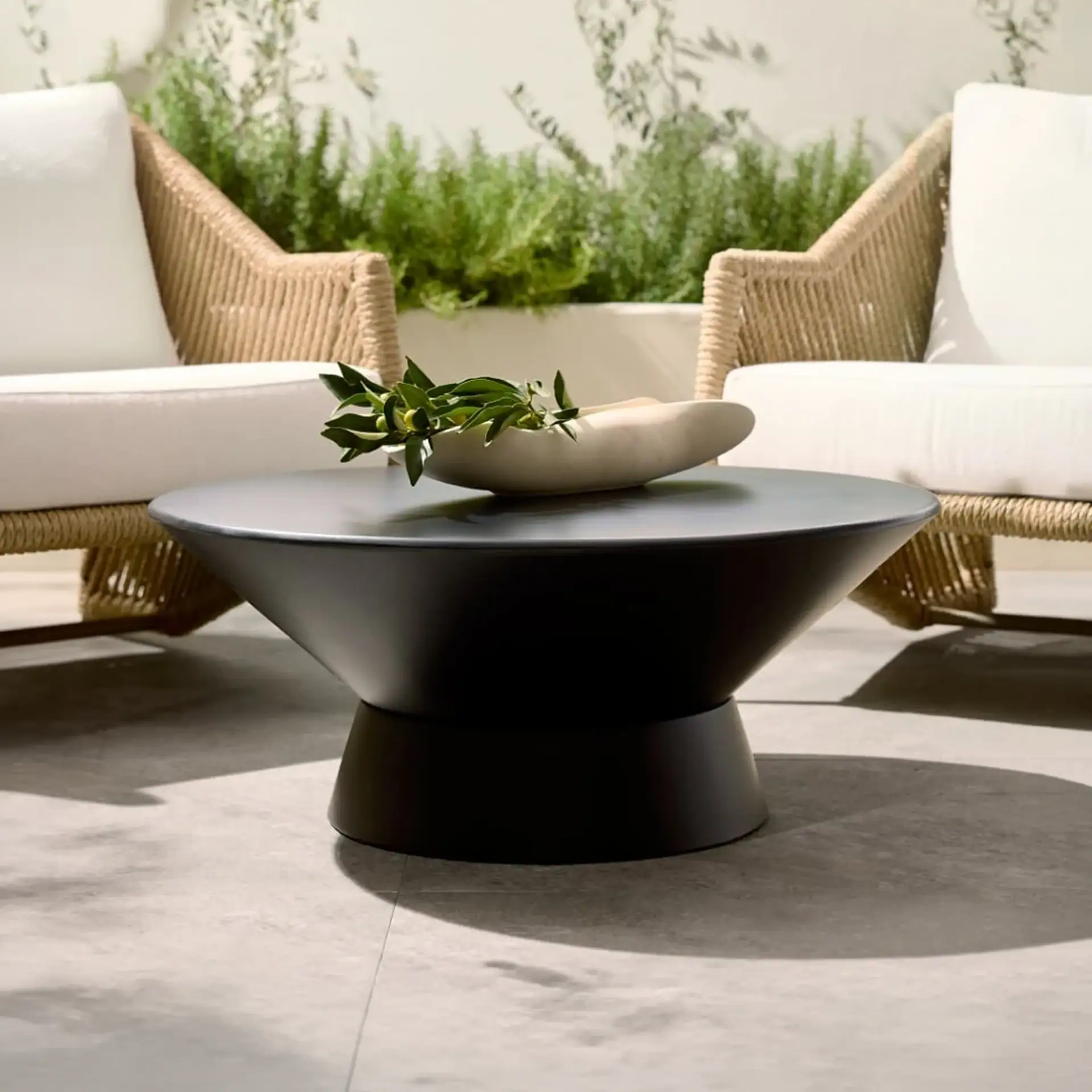 Stylish wicker lounge chairs with a sleek coffee table in a contemporary outdoor setting.