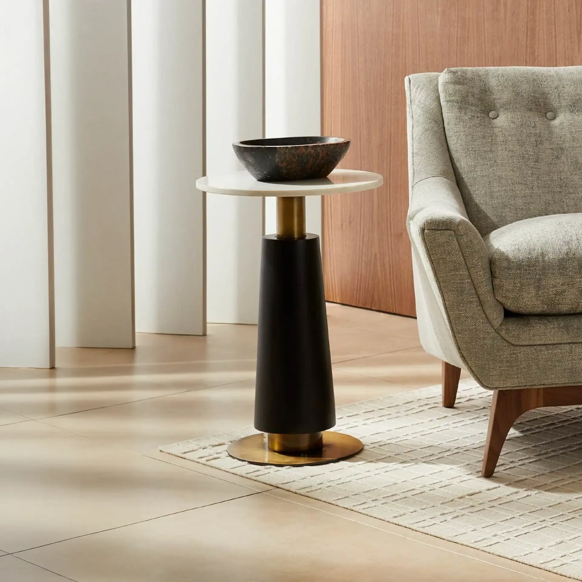 Elegant contemporary side table featuring black and gold details, perfect for modern living room dec.