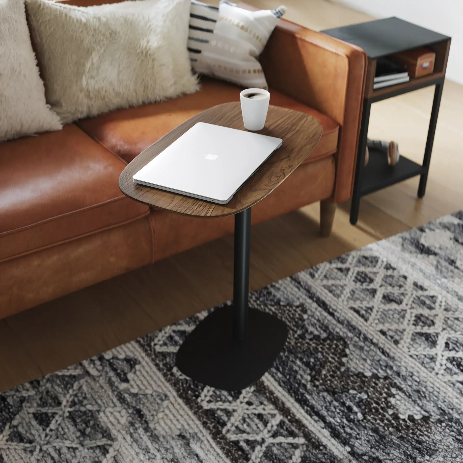 Modern BDI Serif Lift Laptop Table with wood finish and black base.