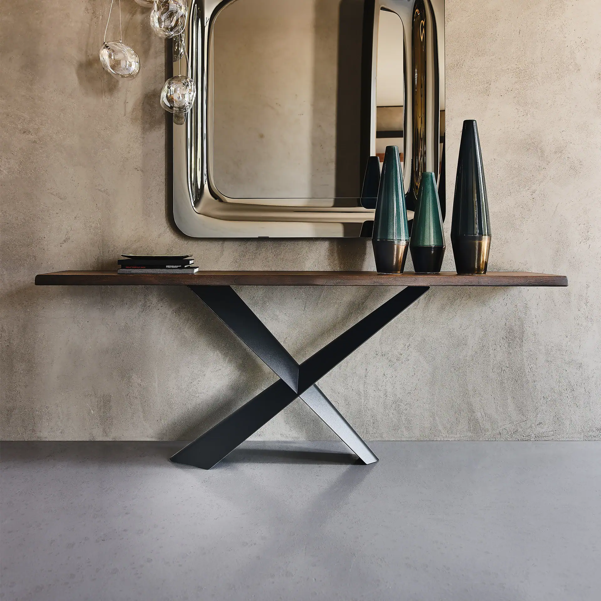 Elegant modern console table with a sleek wooden top and sculptural black metal base.