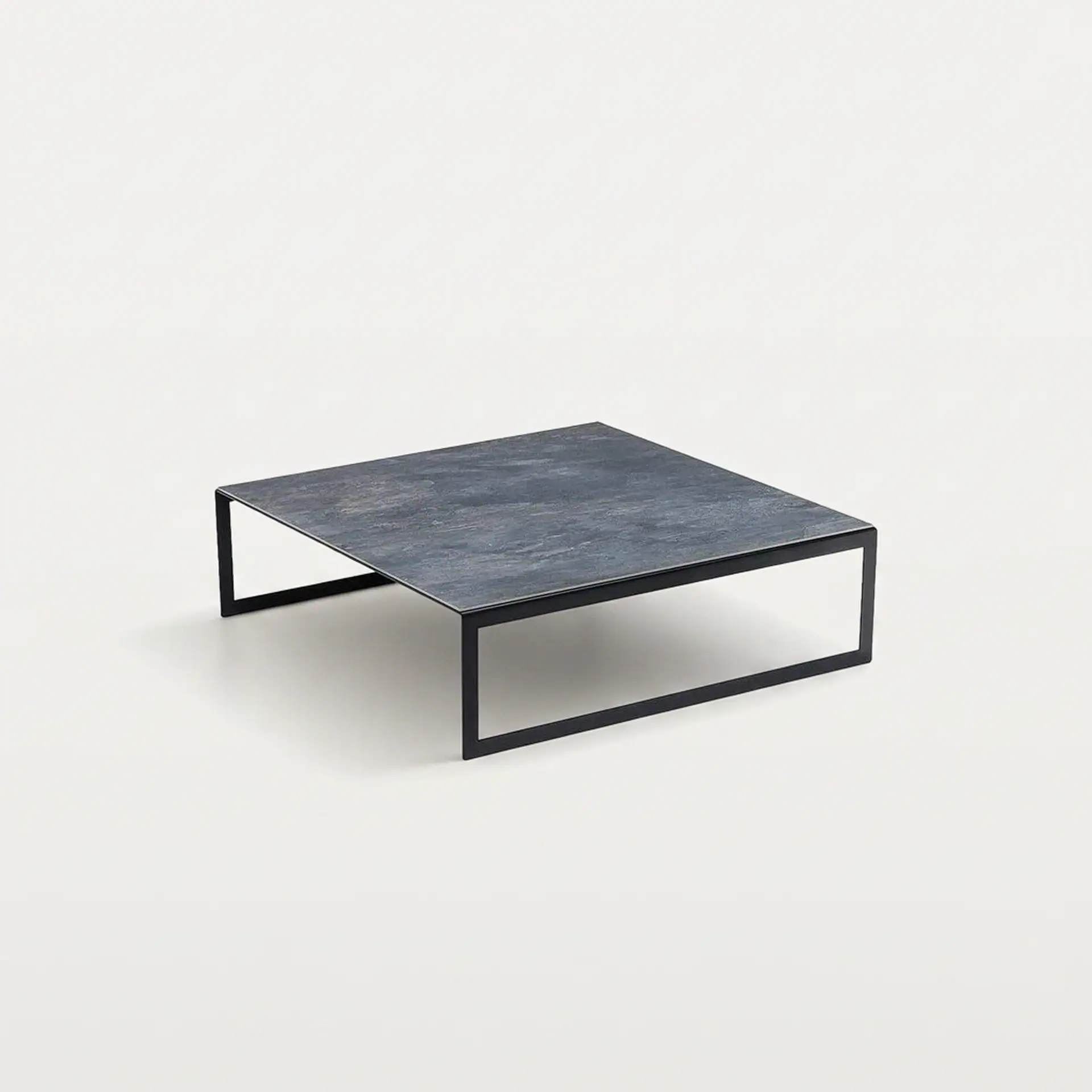 Modern black stone coffee table with sleek metal frame.