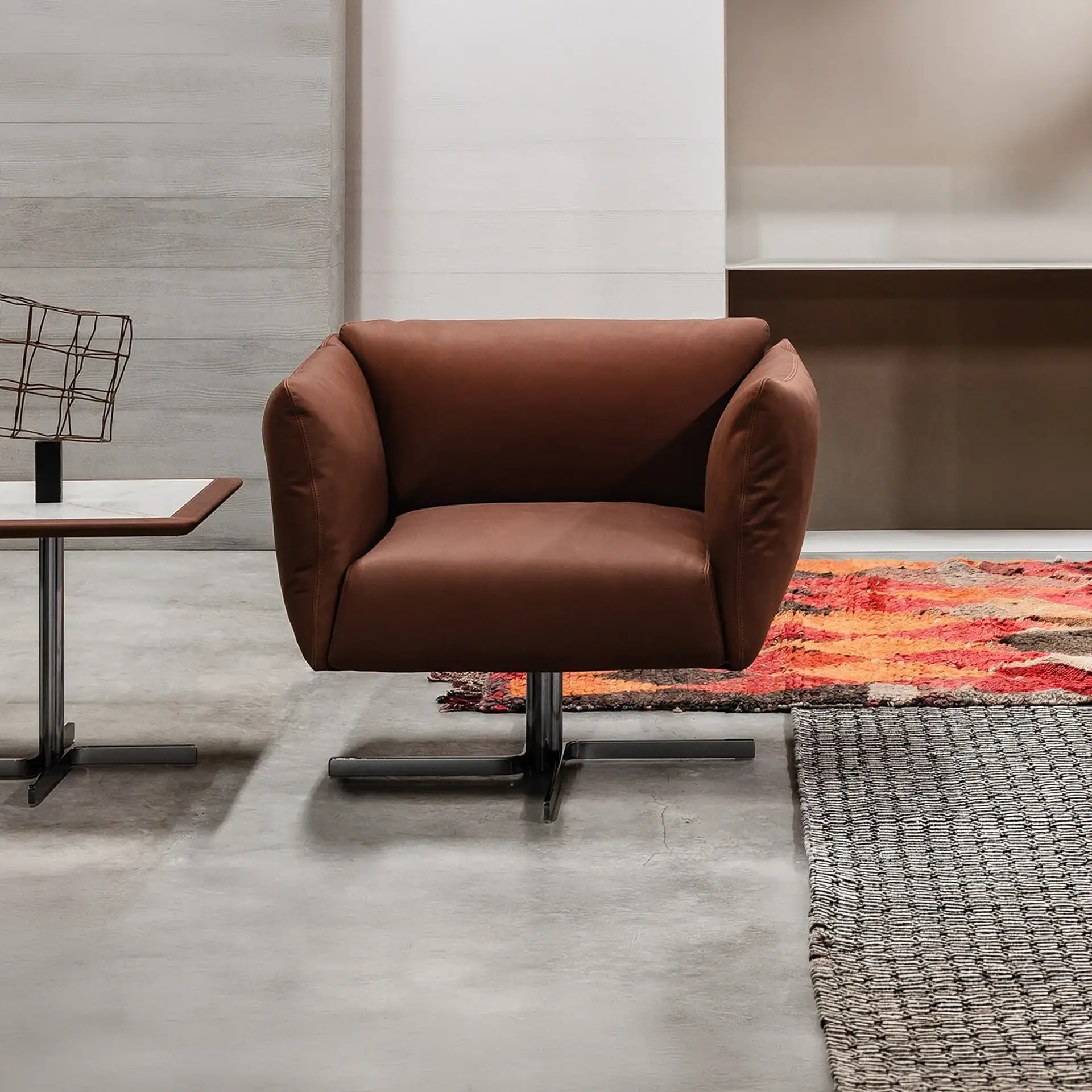 Amelie swivel armchair with plush brown upholstery and modern design. Perfect for contemporary livin.