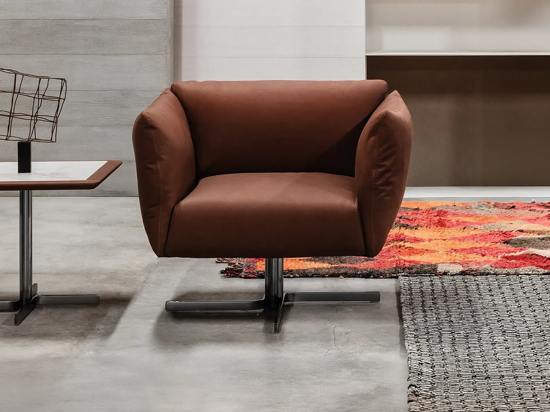 Elegant Cierre Amelie swivel armchair in rich brown upholstery. Perfect for modern living rooms and.