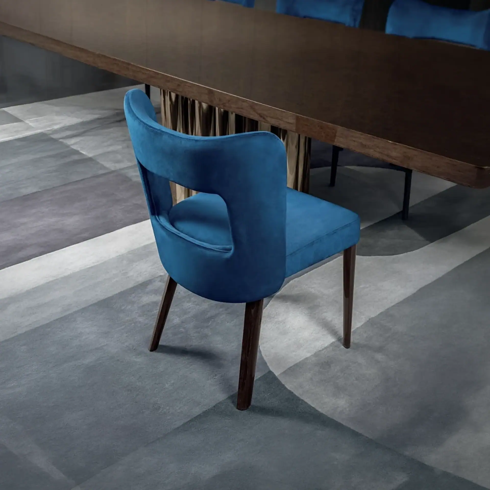 Blue upholstered dining chair with wooden legs, perfect for contemporary dining rooms.