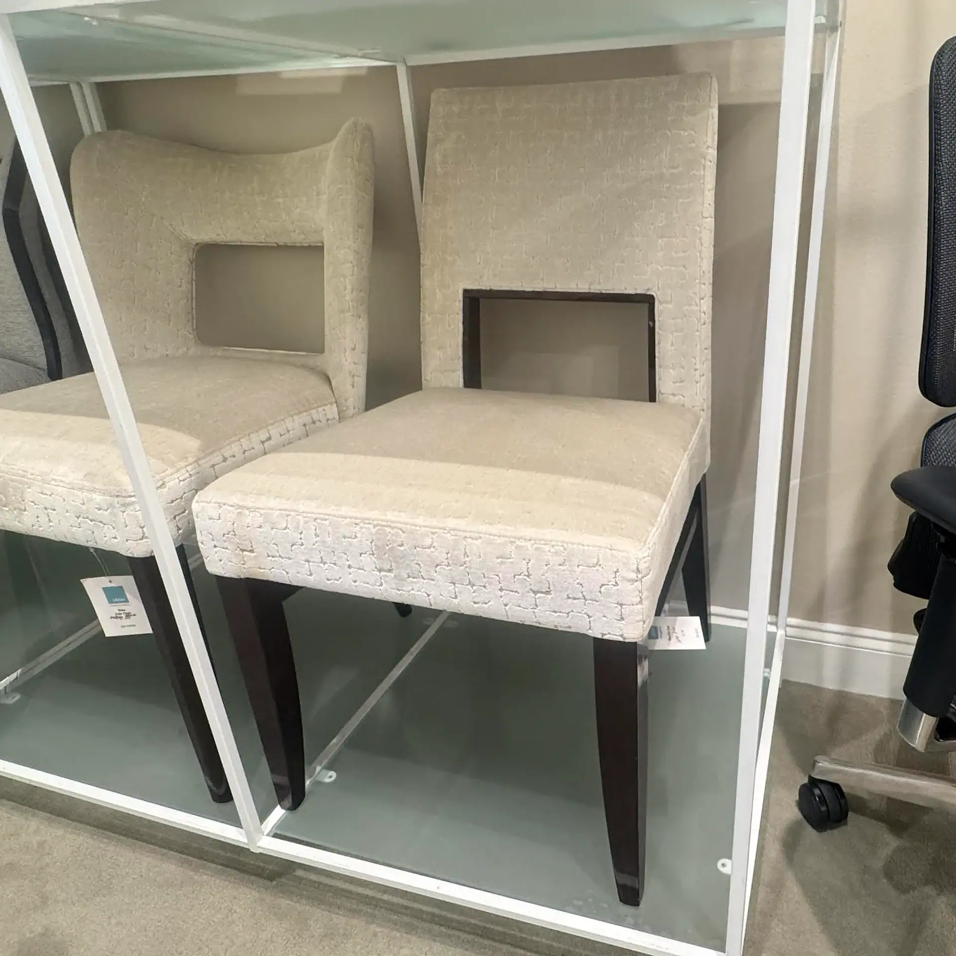 Beige upholstered dining chairs with dark wooden legs, perfect for contemporary dining rooms.