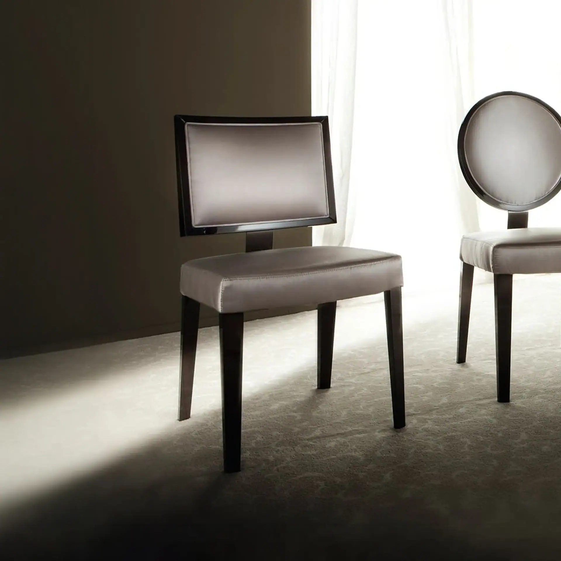 Stylish contemporary dining chairs with upholstered seats and distinctive backrest designs, ideal fo.