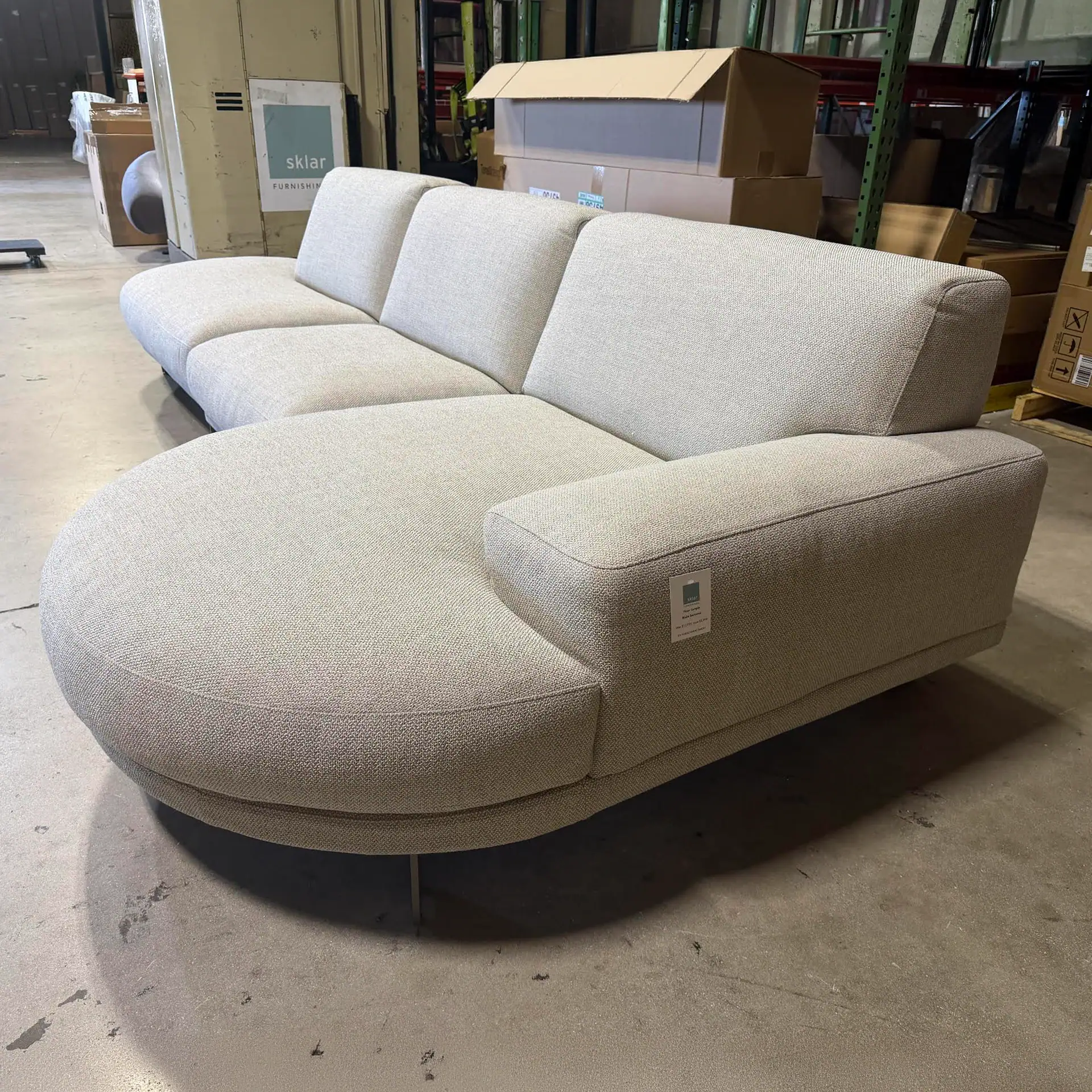 Modern Blake low rounded terminal sofa in light fabric for stylish living rooms.