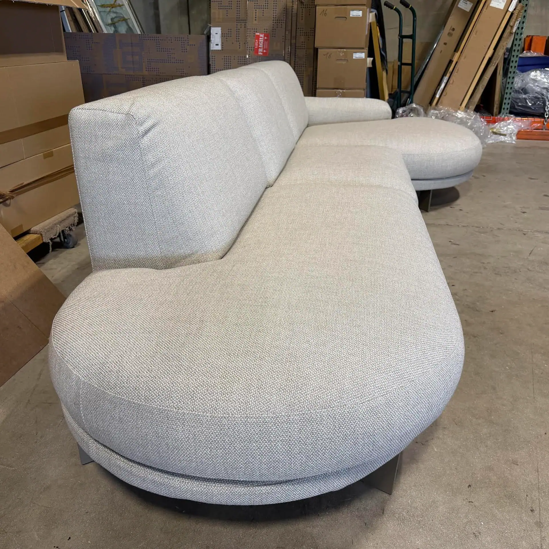 Rounded terminal sofa with plush upholstery for modern living spaces.