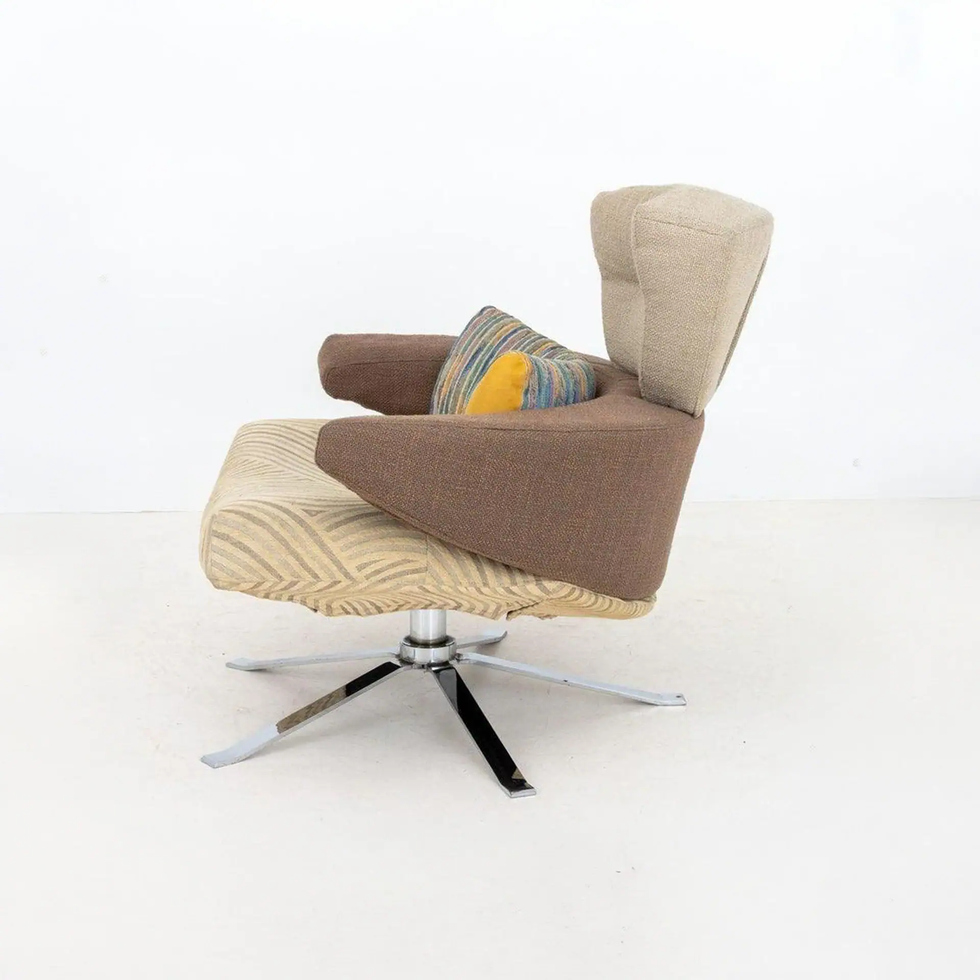 Contemporary Mary Armchair with mixed fabric upholstery and metal base.
