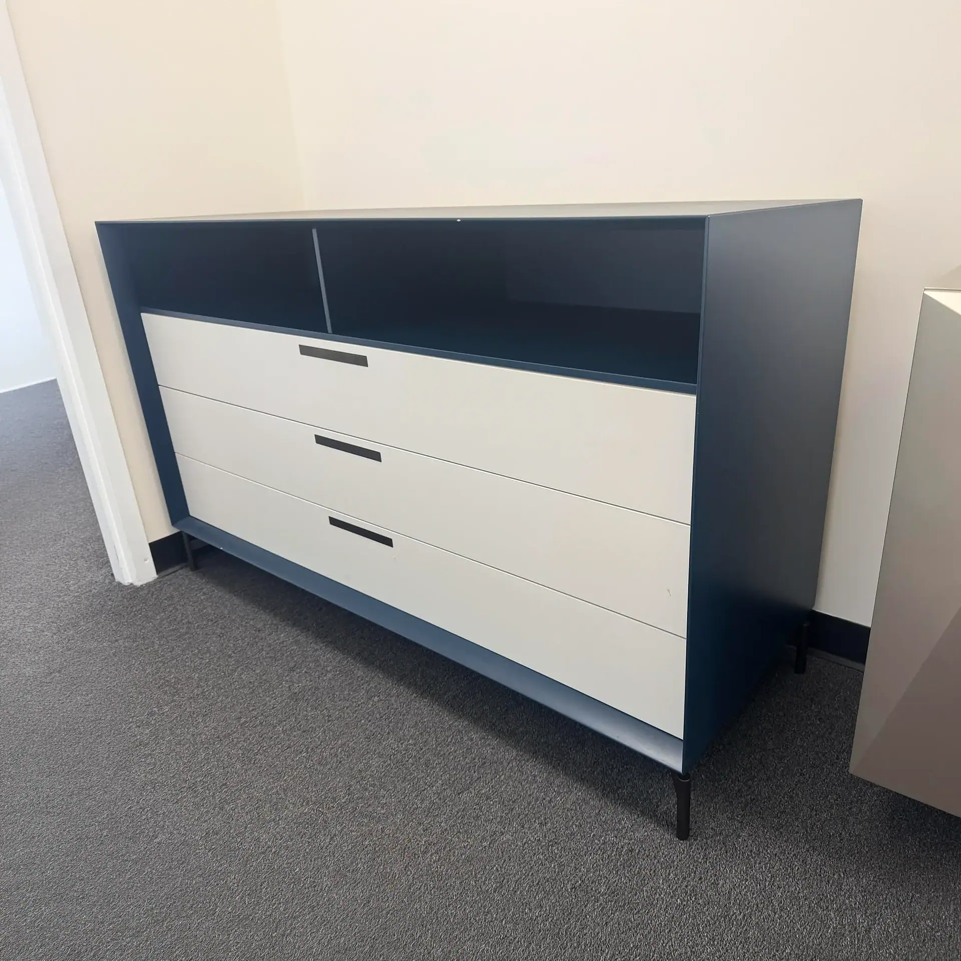 Stylish black and white dresser with three spacious drawers and open shelf for storage.
