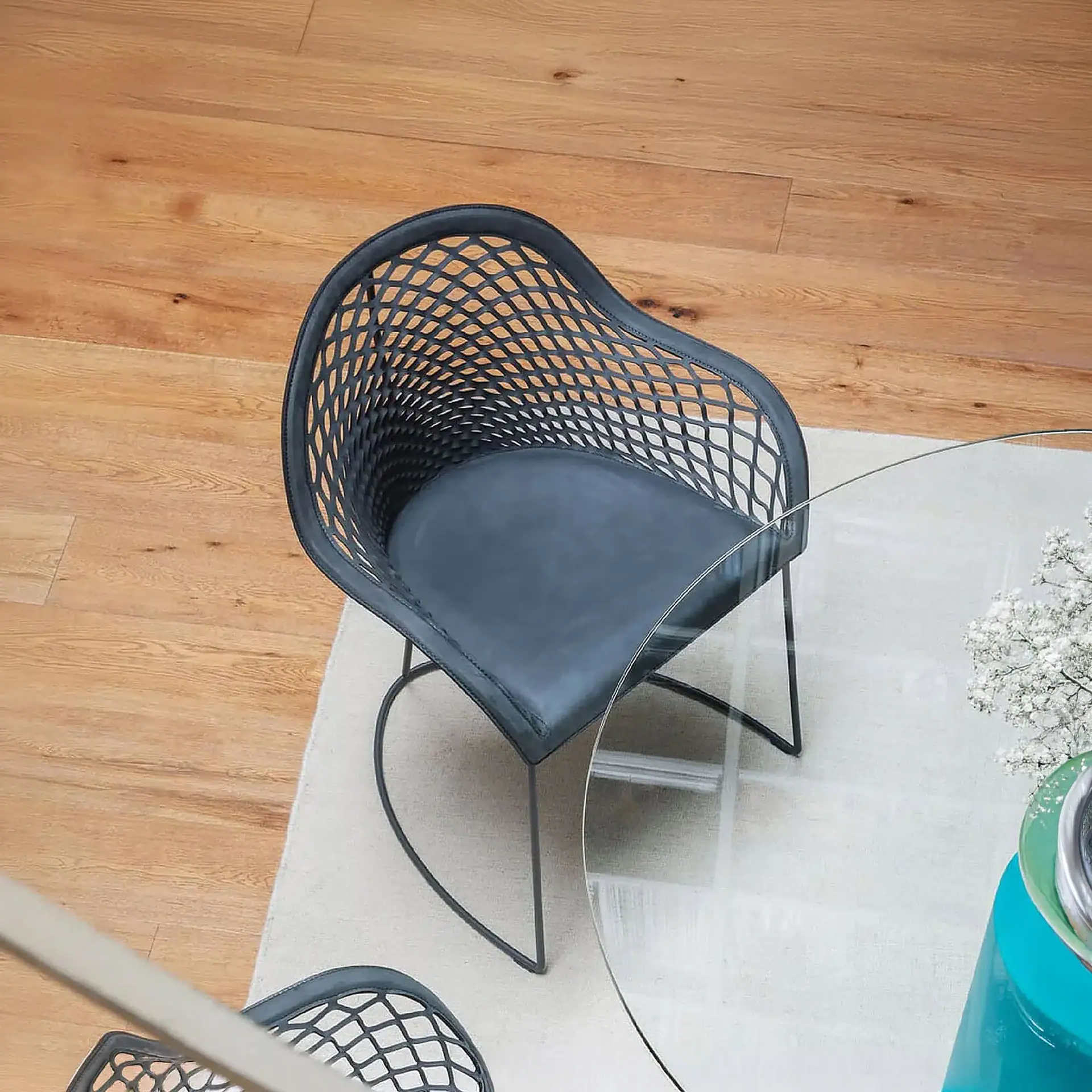 Black woven accent chair with a sleek metal frame, perfect for contemporary living spaces.
