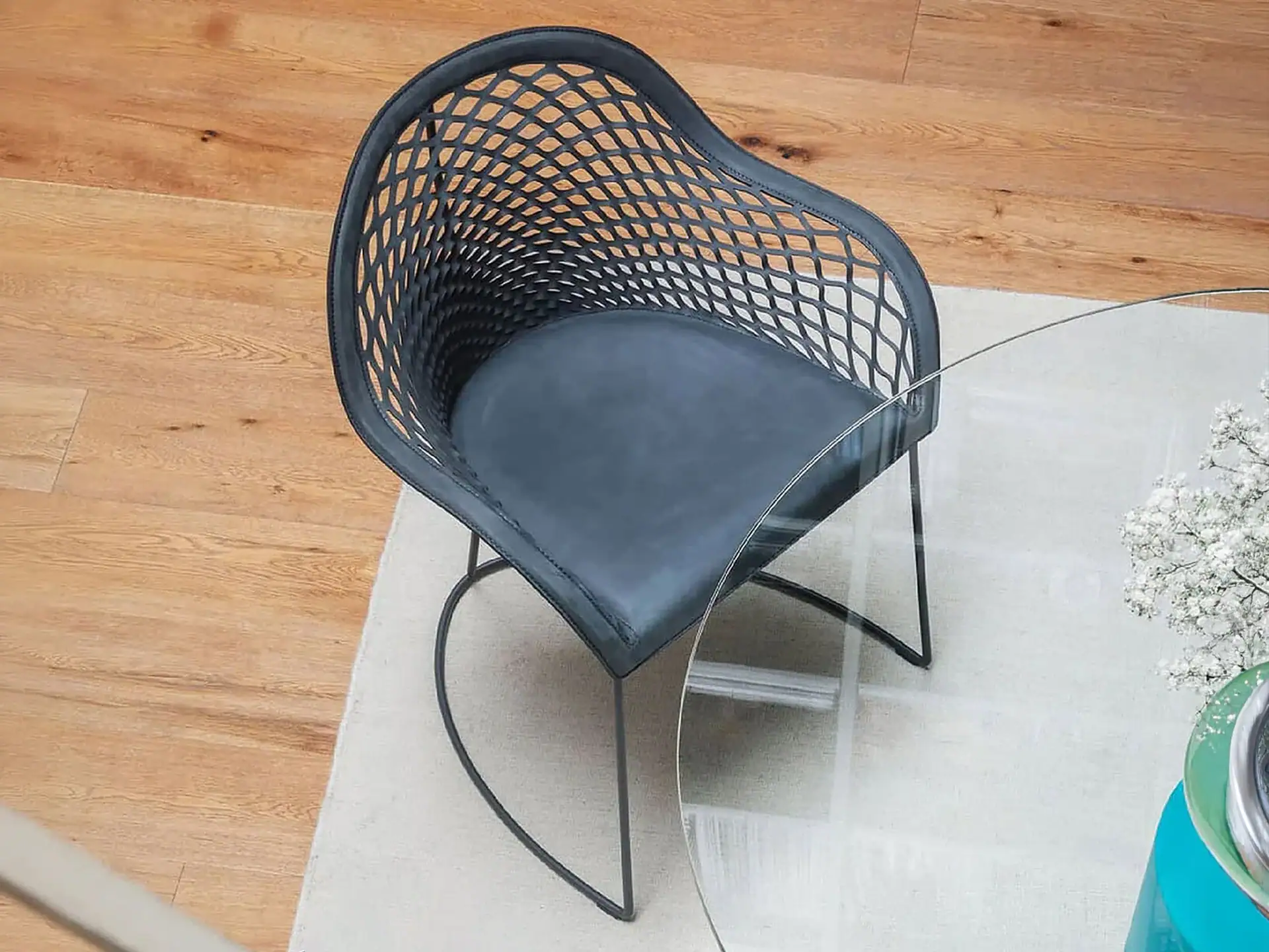 Black woven accent chair with metal legs for stylish comfort.