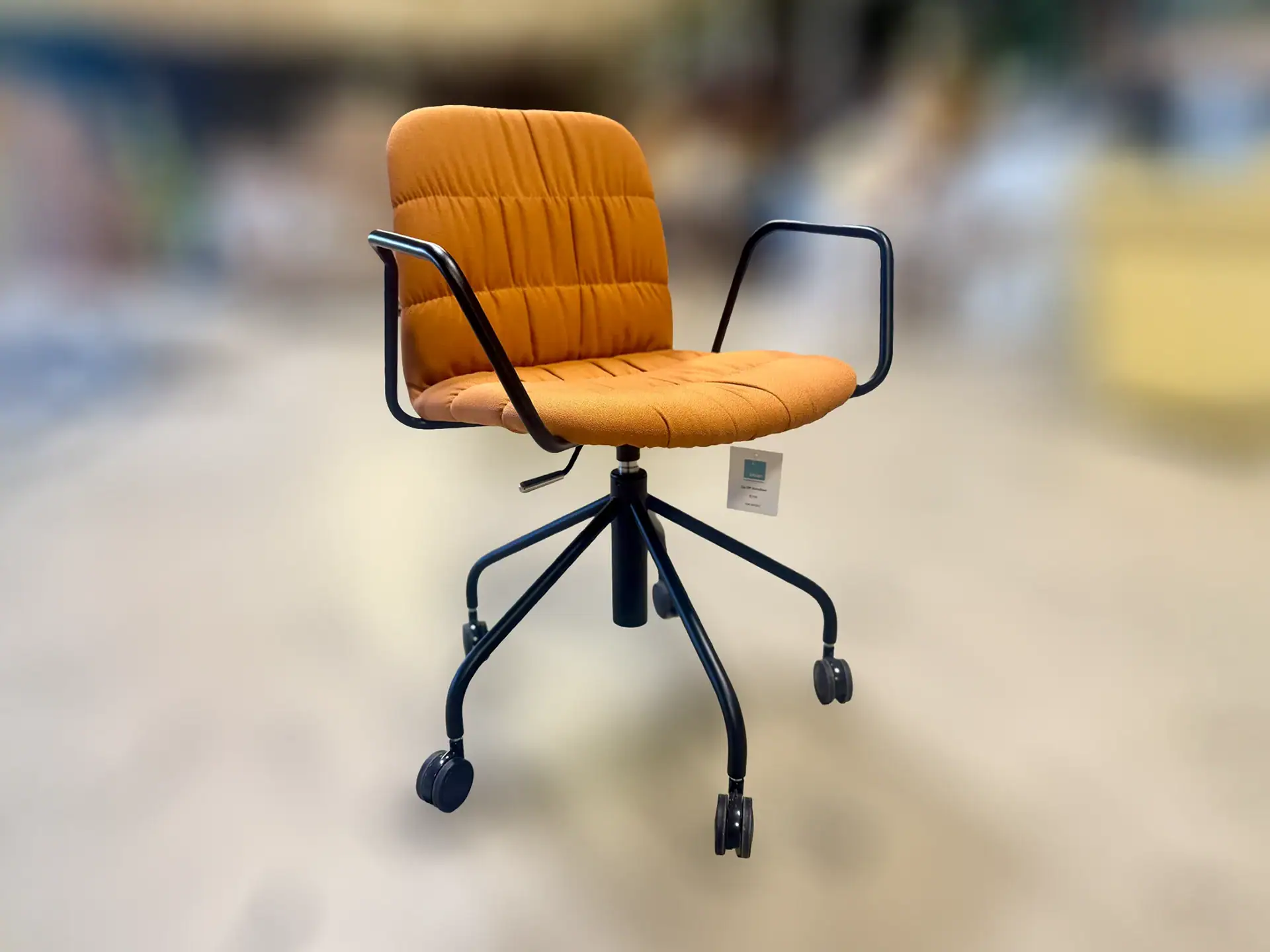 Orange office chair with black metal arms and wheels for mobility.