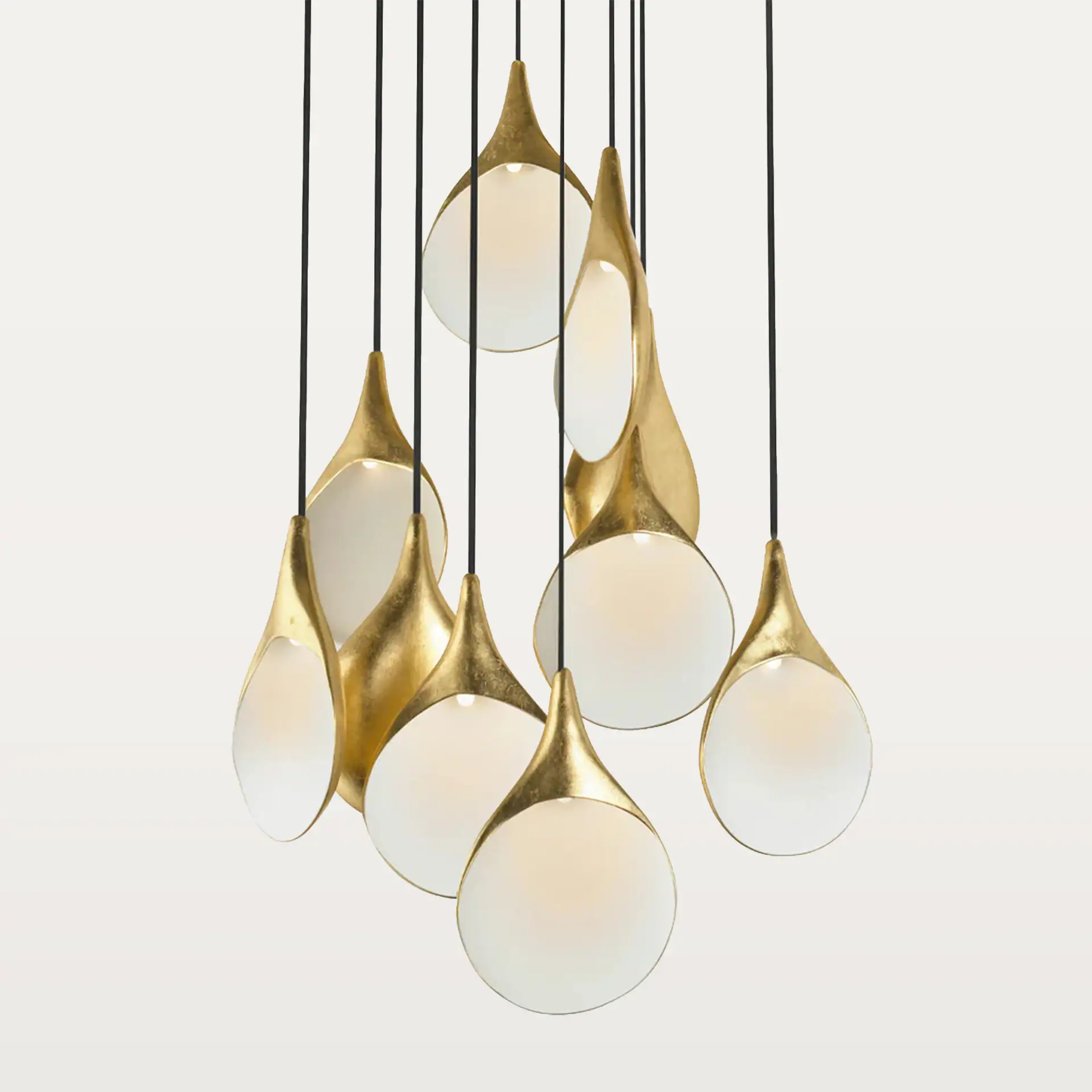 Chandelier featuring gold-finished elements and frosted glass globes, perfect for modern interior li.