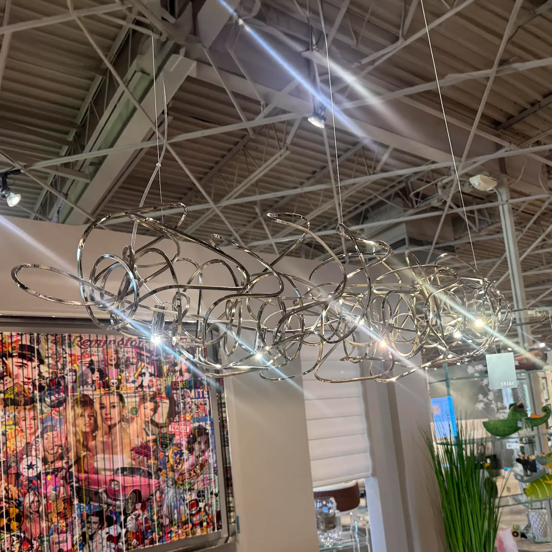 Doodle Linear Suspension Lamp by Terzani, featuring a modern, artistic design with intertwined metal.