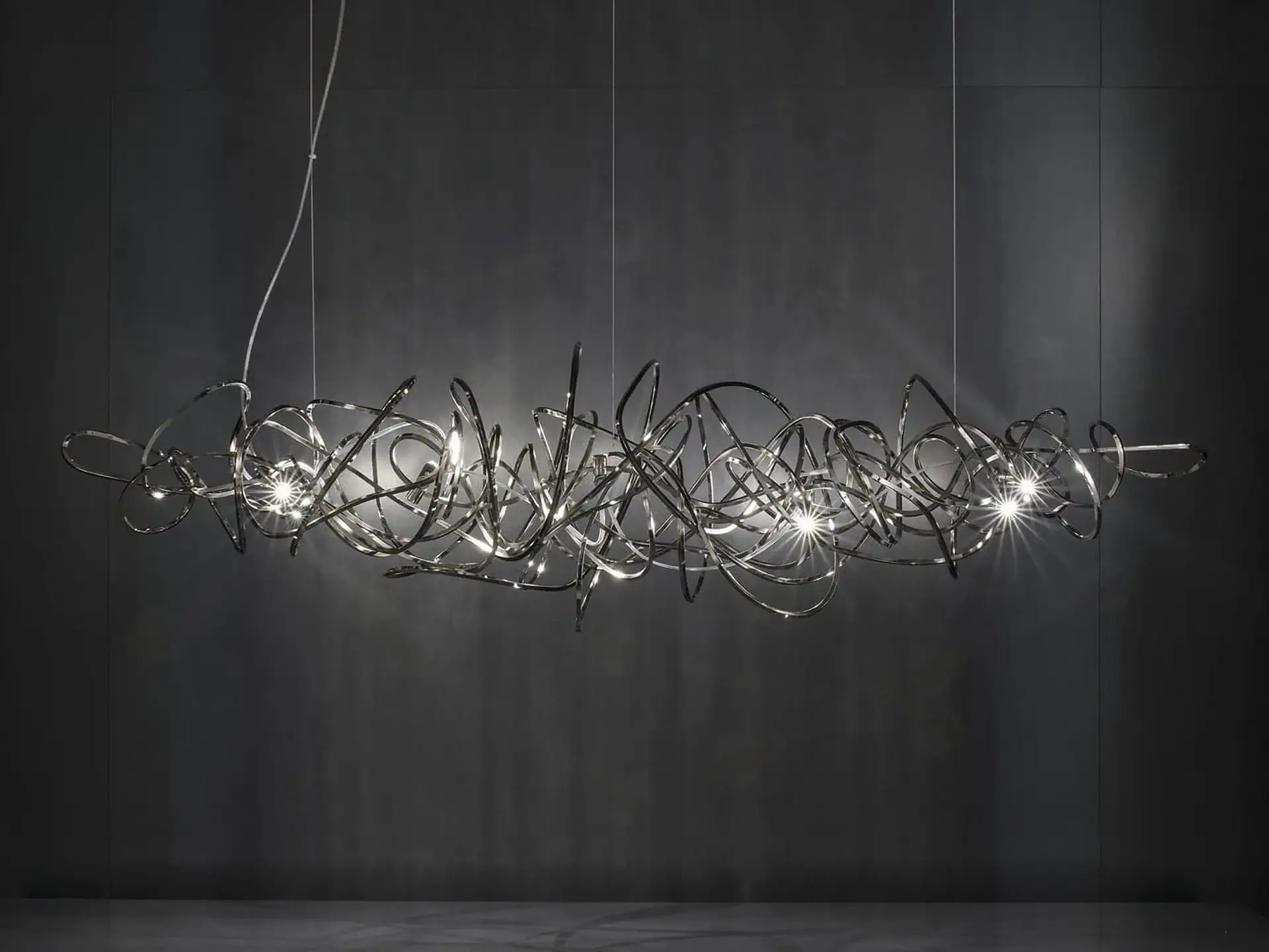 Suspension lamp with intricate, artistic metalwork design by Terzani, ideal for modern interiors.