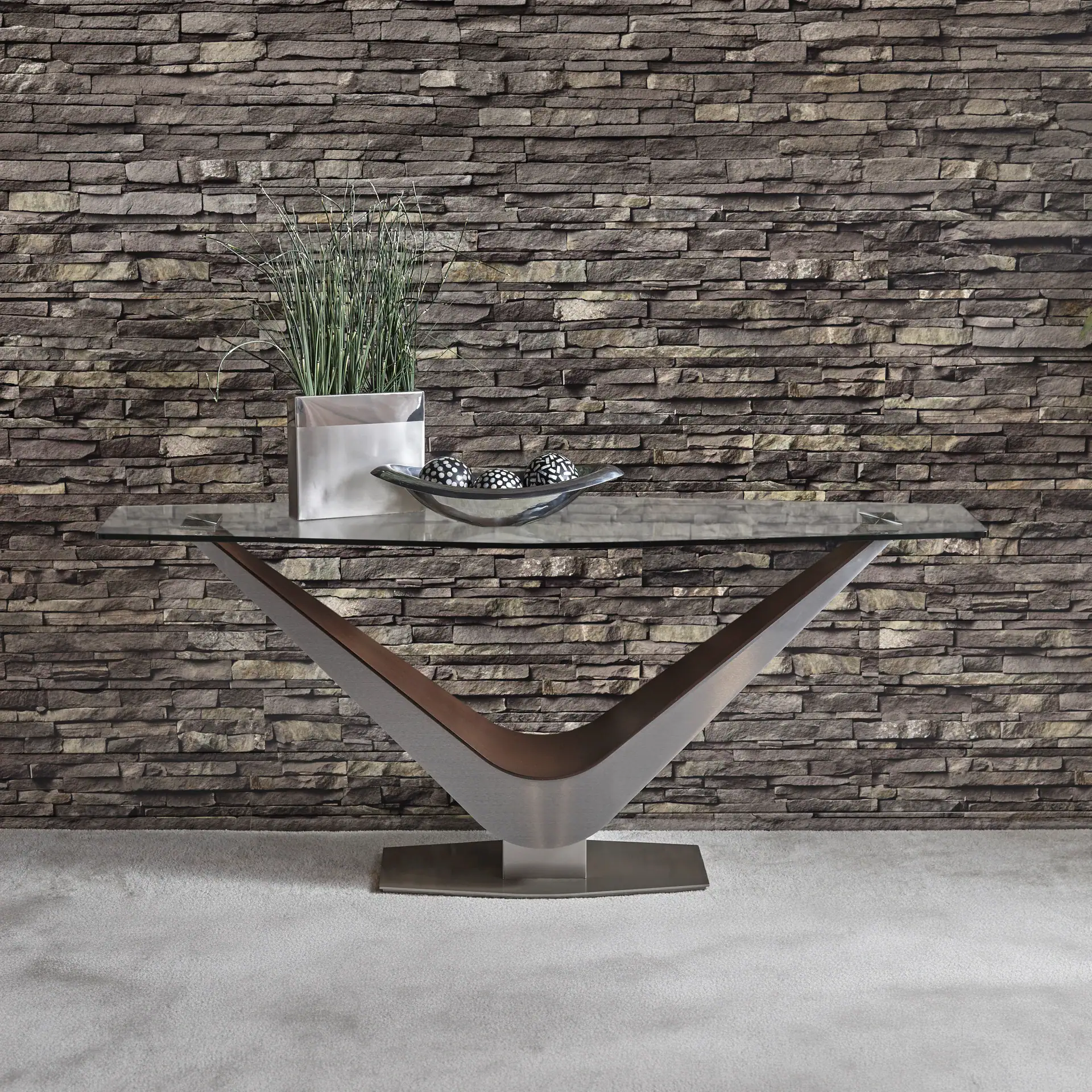 V-shaped modern console table with decorative accents.