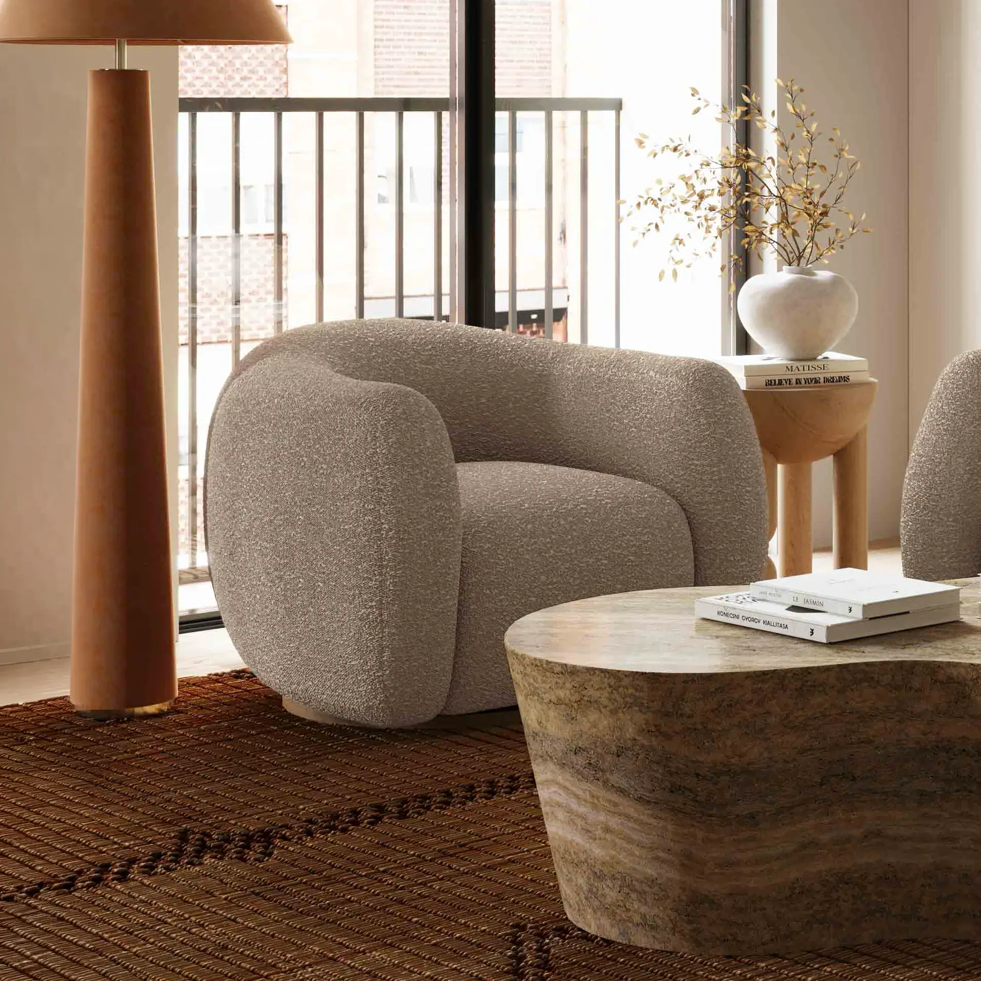 Contemporary beige armchair with rounded design in stylish living room setting.