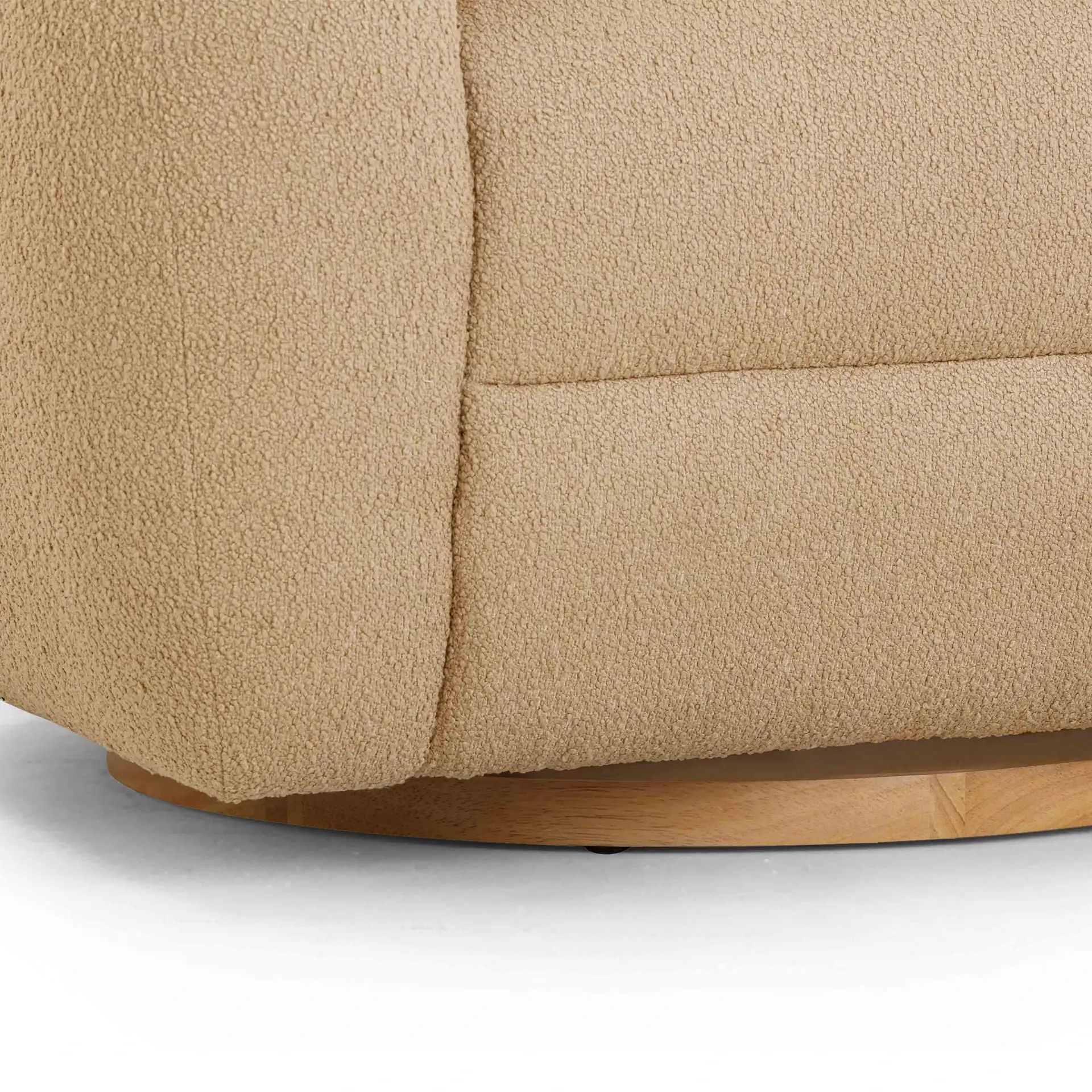 Beige upholstered sofa with wooden base, modern and comfortable furniture piece.