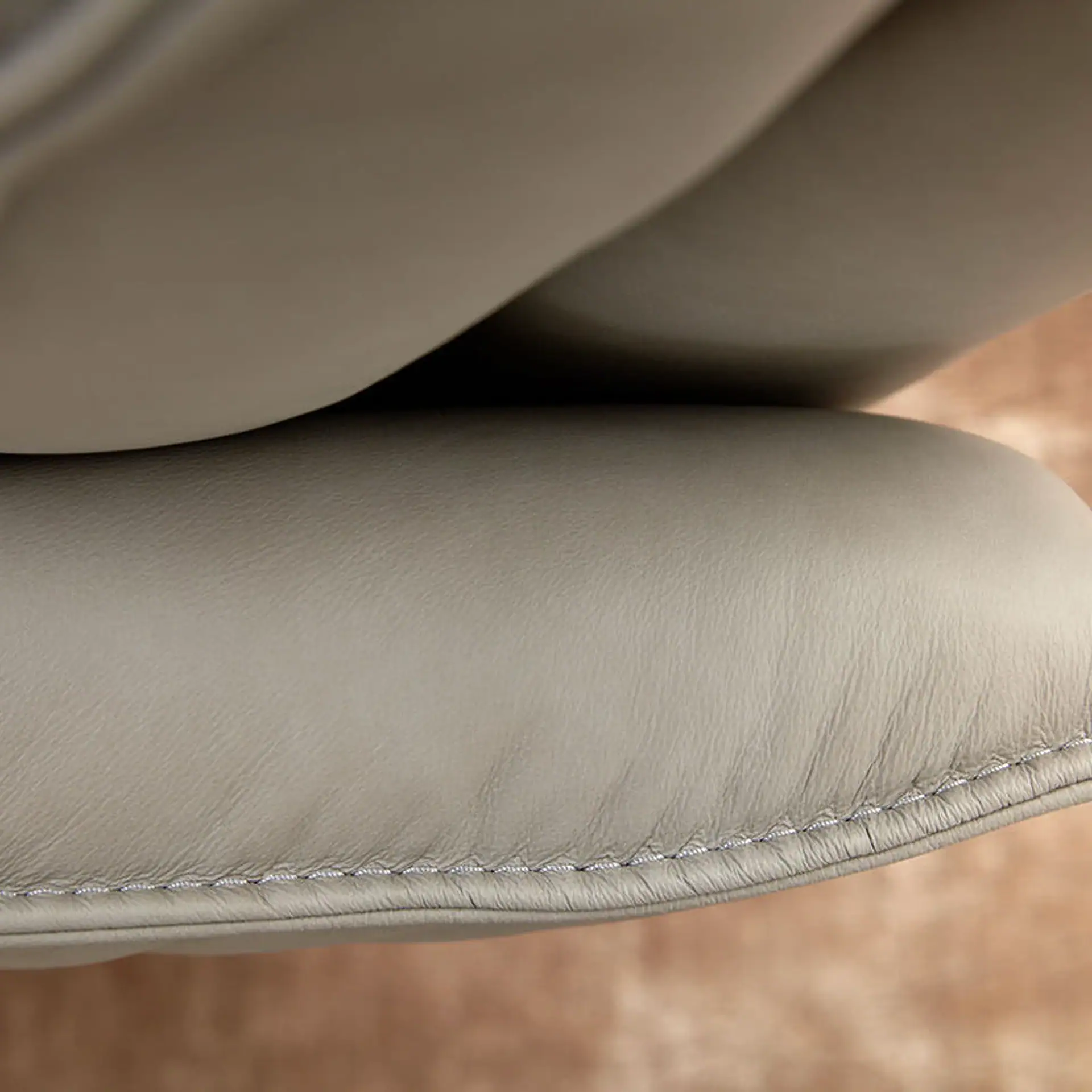 Close-up of the Aura Swivel Recliner Chair's leather upholstery.