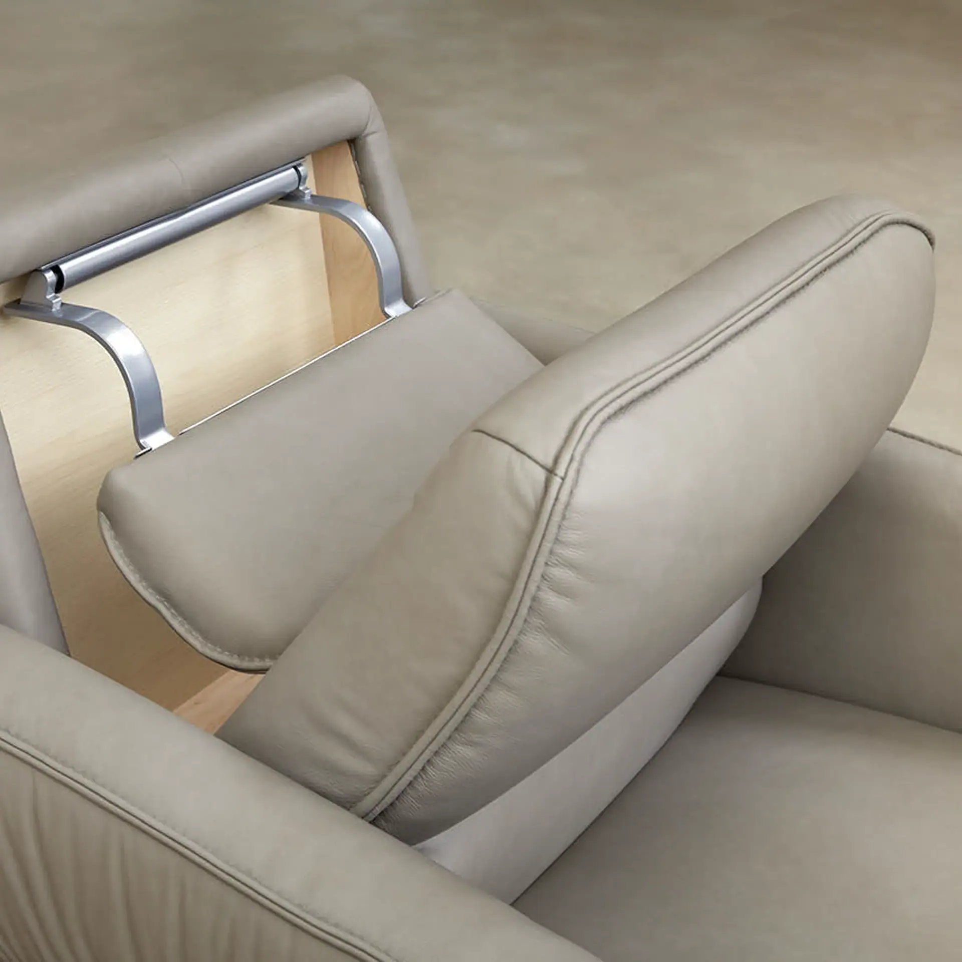 Aura Swivel Recliner Chair with beige leather upholstery and wooden accents.