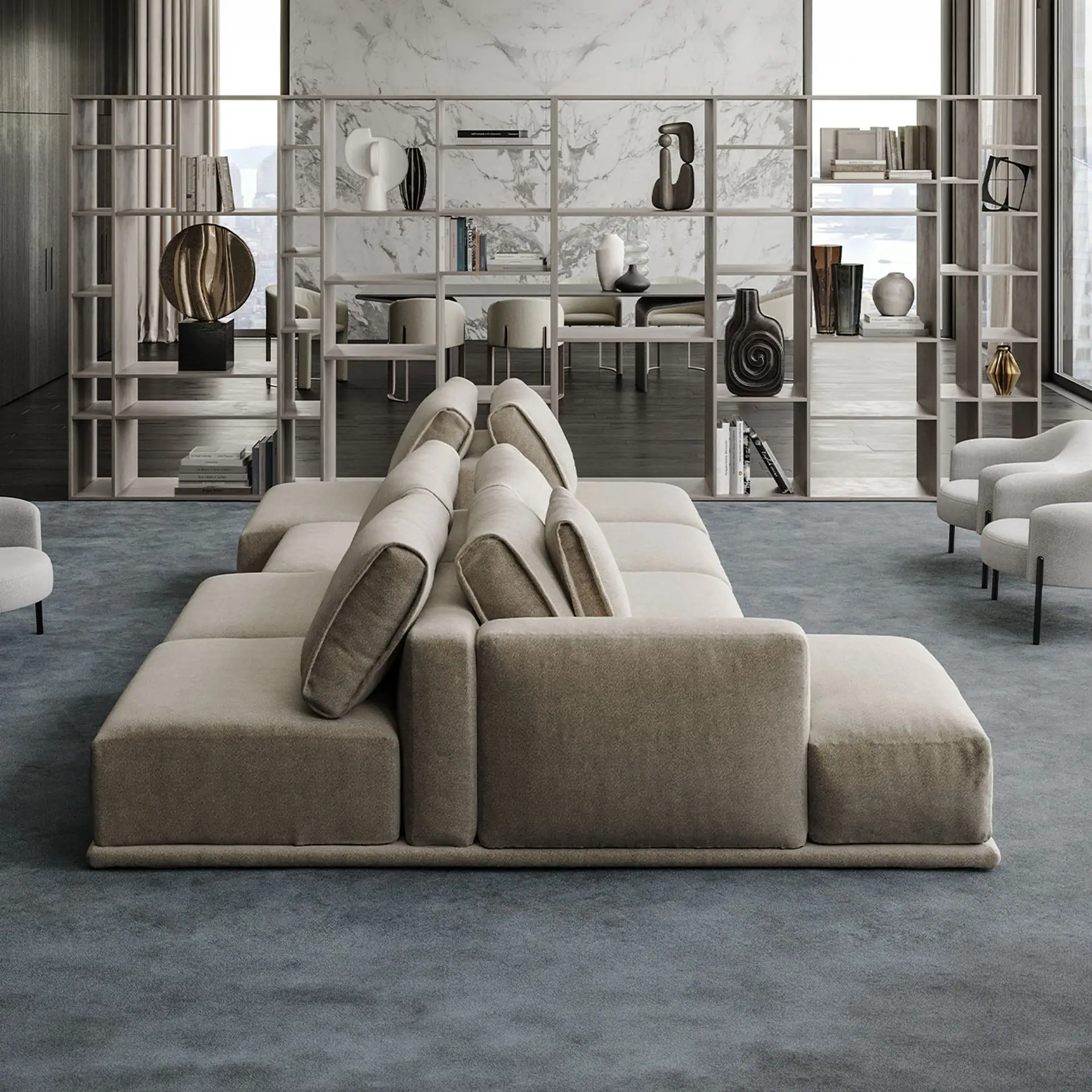 Double-sided sofa in a contemporary living room with neutral tones and stylish decor.
