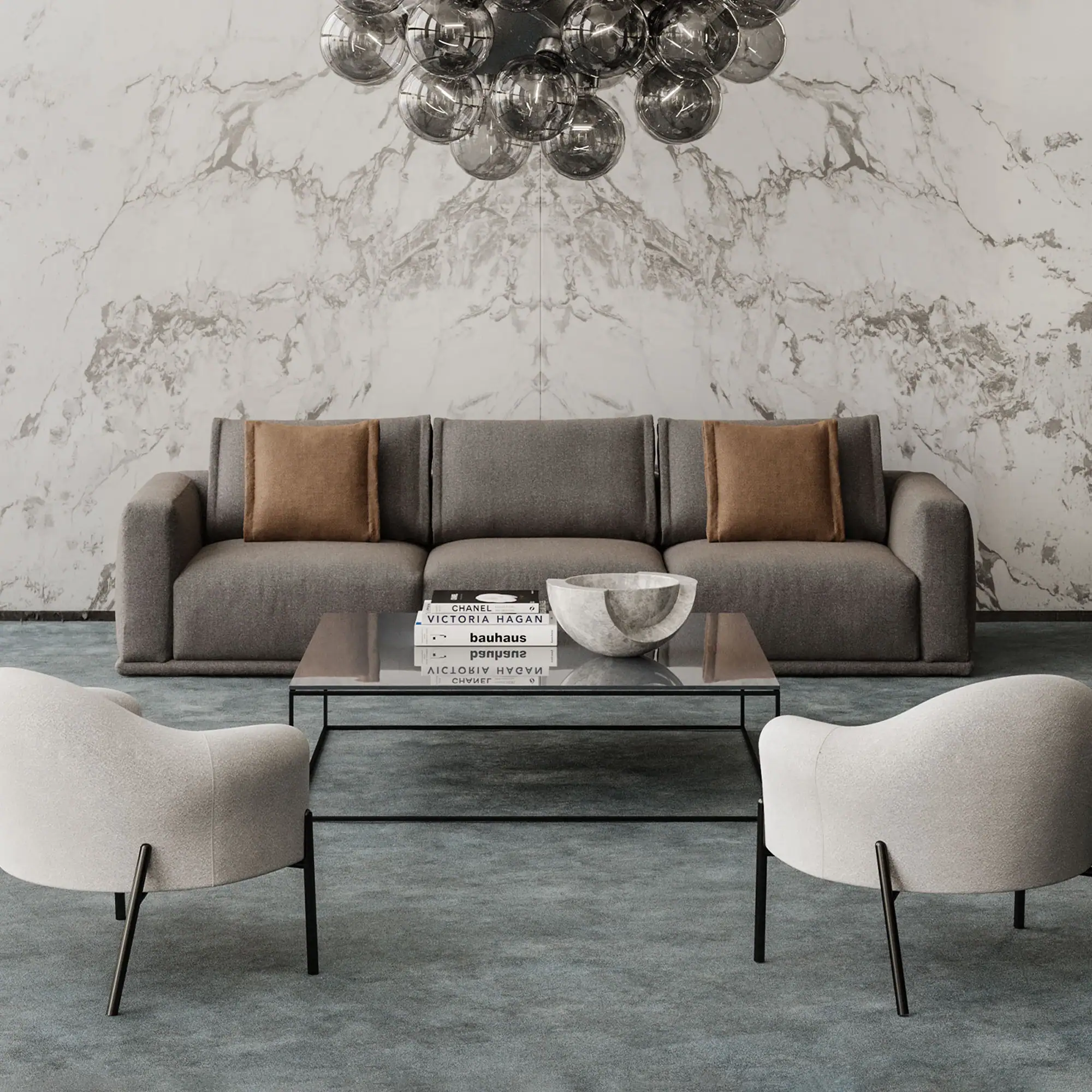 A modern living room with a grey sofa, glass coffee table, two light armchairs, and a smoky globe chandelier against a white marble wall.
