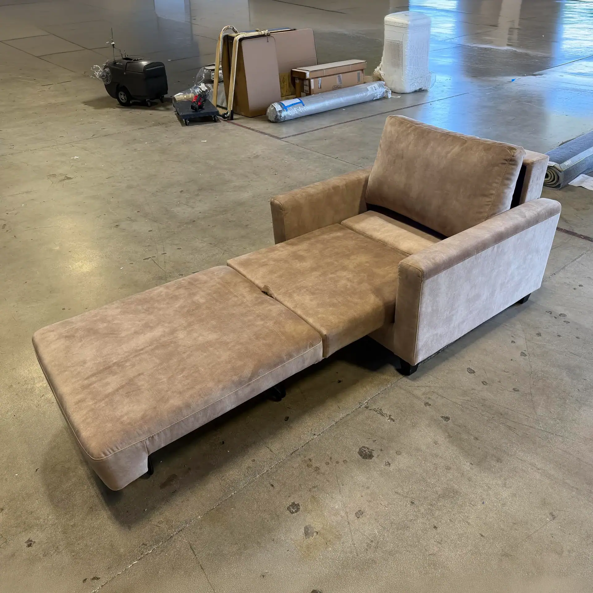 Comfortable beige sleeper chair with extendable bed for versatile seating.