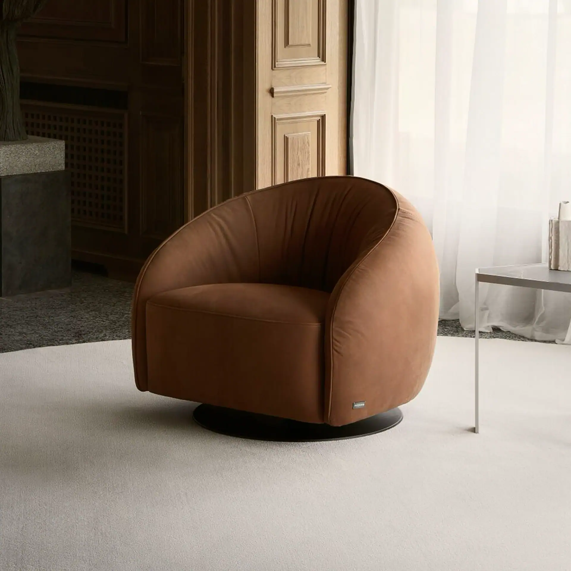 Swivel armchair with plush brown upholstery in a modern living room setting.