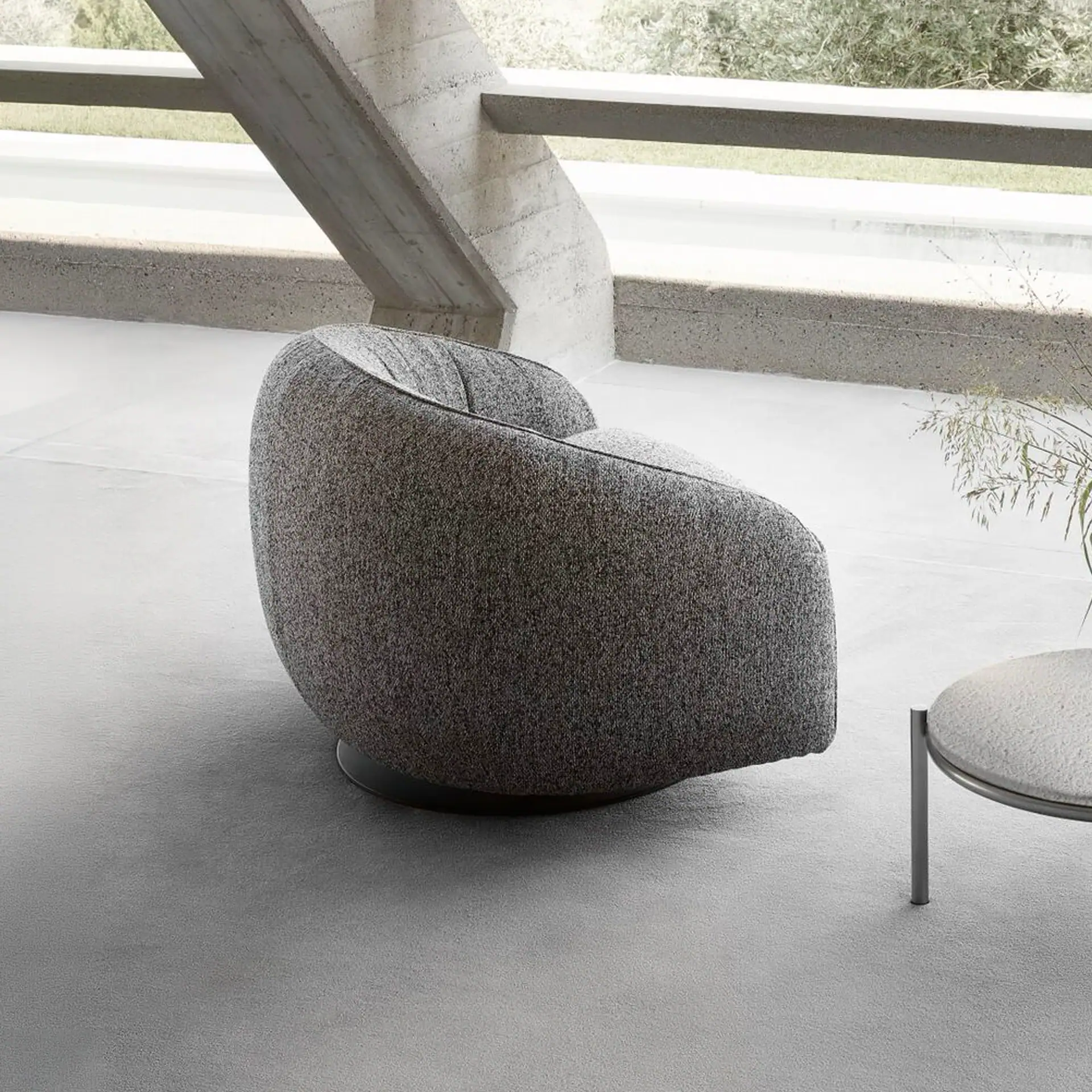 Elegant grey Nest swivel armchair for modern living spaces.