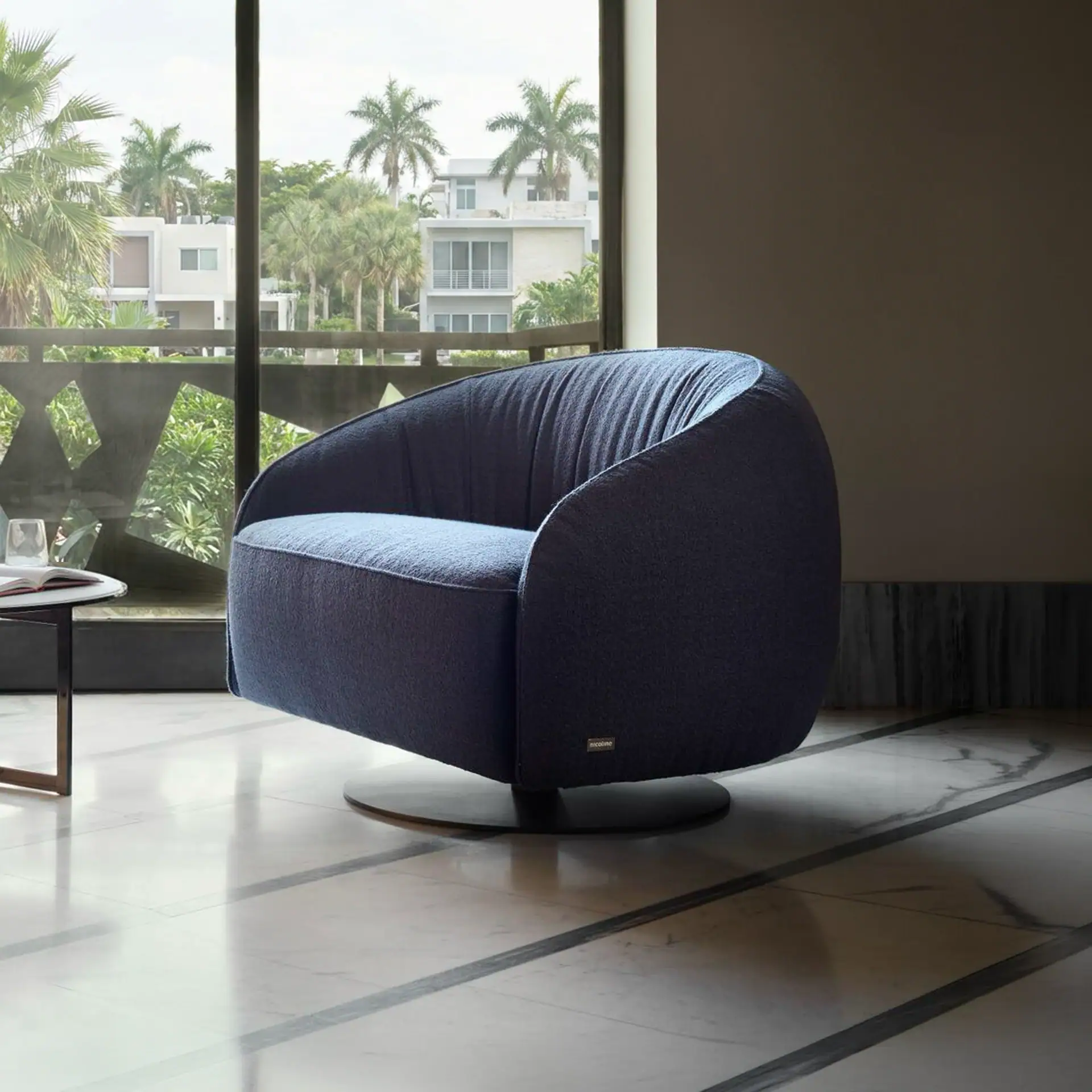Modern blue Nest swivel armchair in a stylish living room setting.